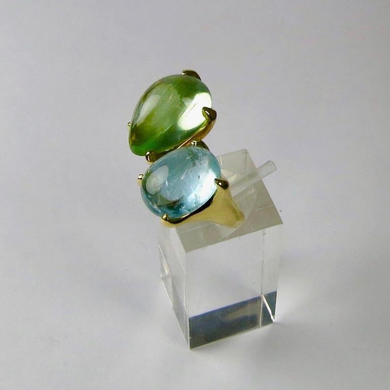 Contemporary cabochon aquamarine and pear shaped beryl crossover ring set in 18 carat yellow gold. Please note this item is made to order and a similar but not identical piece can be made. Allow four weeks to delivery. 

Esther Eyre has been