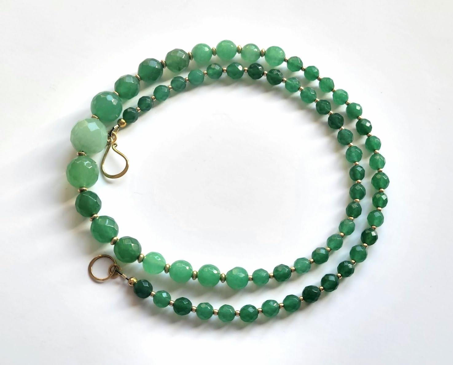 The length of the necklace is 23 inches (58.4 cm). The size of the beads varies from 6 mm to 13 mm.
The color of the faceted beads is vibrant, saturated, apple green, semi-transparent, and emerald green.
Each bead was cut, faceted, and polished by