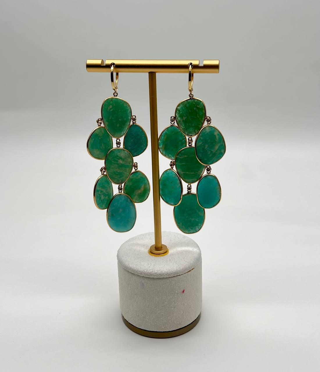 A striking pair of green & blue Amazonite and diamond earrings in 14 karat gold. The earrings feature 85.27 carats of green Amazonite, accented by 0.23 carats of diamonds.