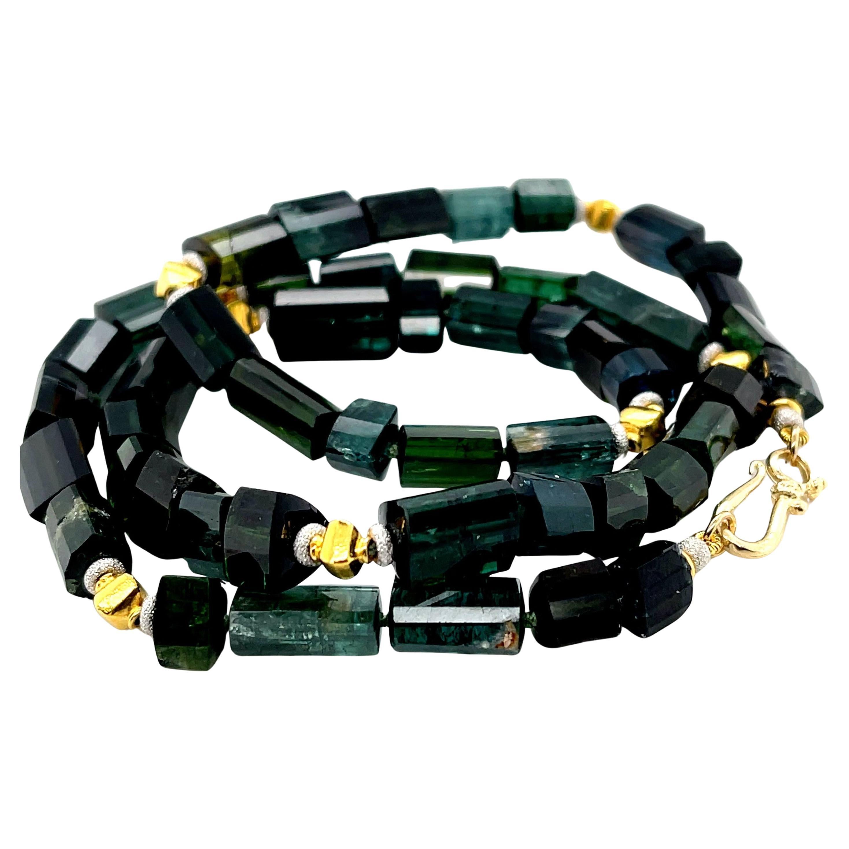 This versatile necklace features a beautiful collection of naturally occurring tourmalines in the blue, green and teal color family. The semi-transparent tourmalines have been faceted as triple-sided columns that preserve the natural crystal