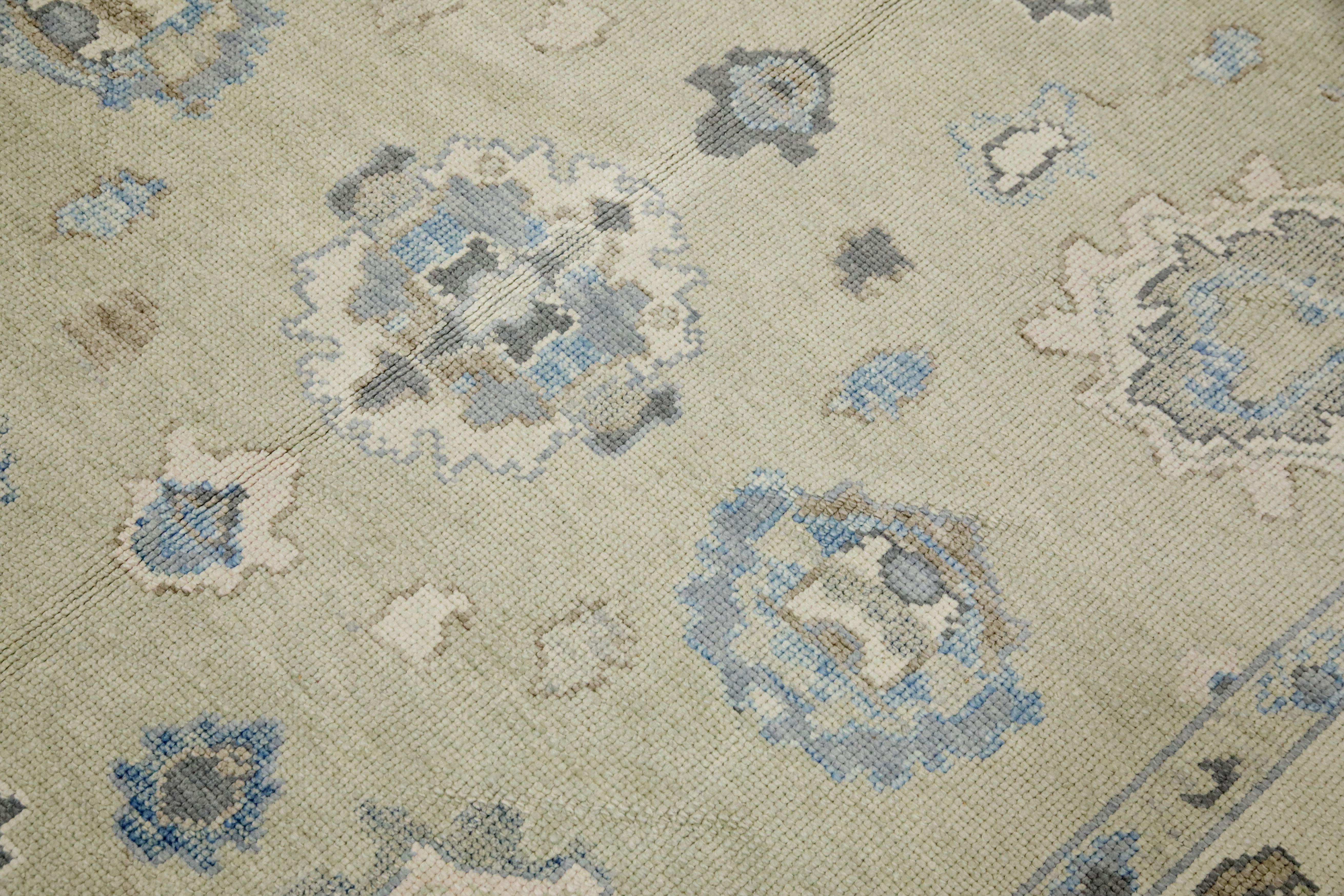 This modern Turkish Oushak rug is a stunning piece of art that has been handwoven using traditional techniques by skilled artisans. The rug features intricate patterns and a soft color palette that is achieved through the use of natural vegetable