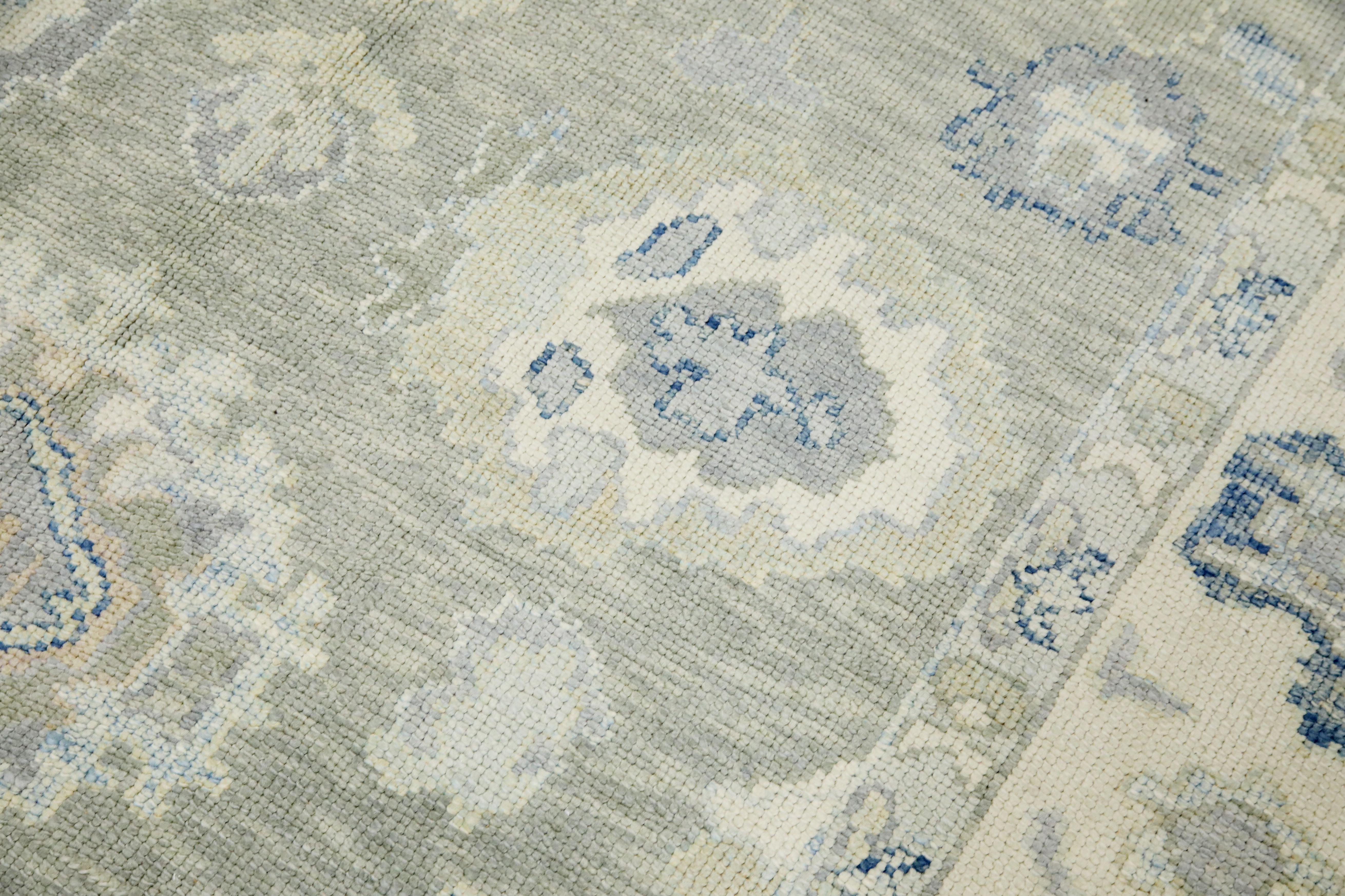 This modern Turkish Oushak rug is a stunning piece of art that has been handwoven using traditional techniques by skilled artisans. The rug features intricate patterns and a soft color palette that is achieved through the use of natural vegetable