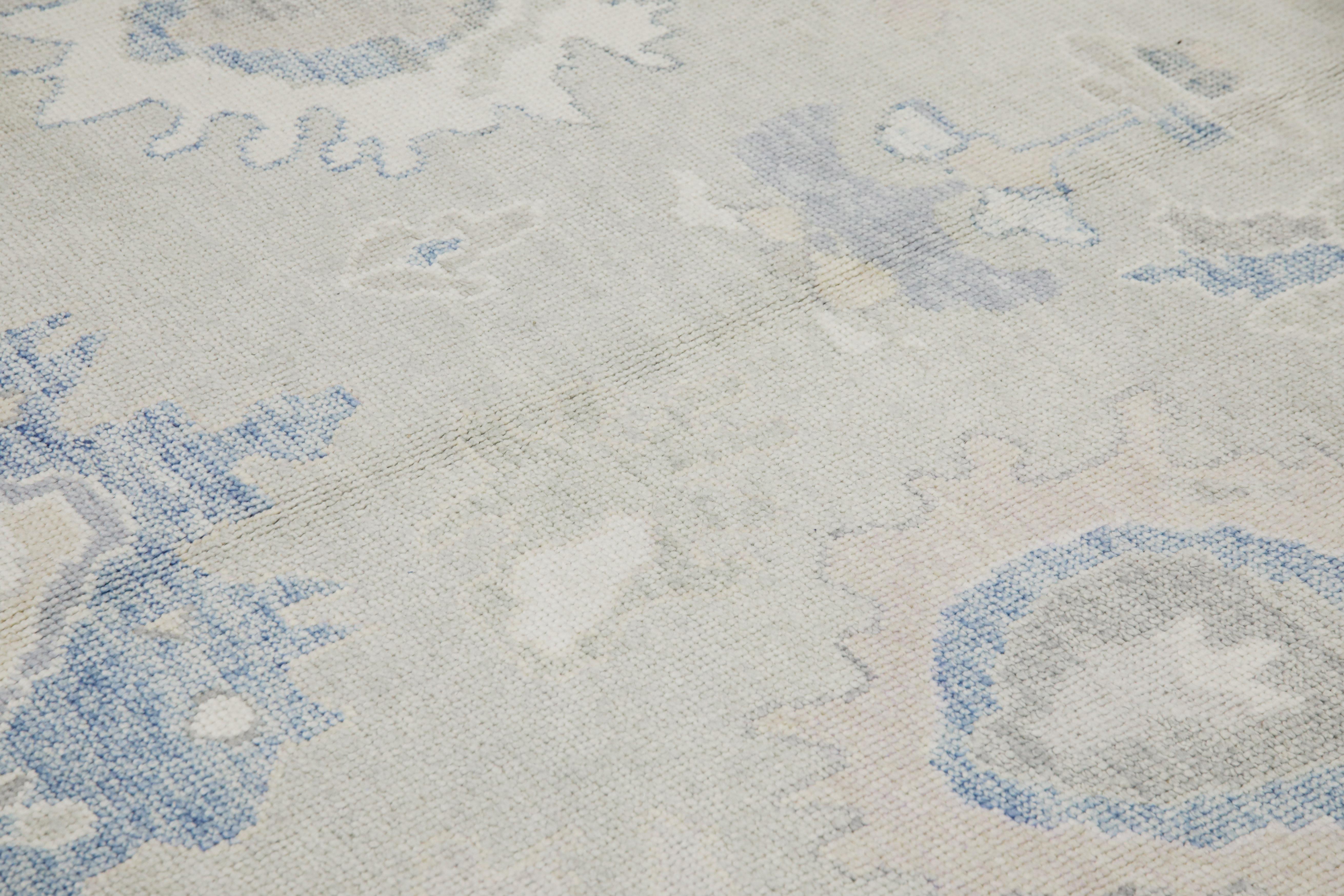 This modern Turkish Oushak rug is a stunning piece of art that has been handwoven using traditional techniques by skilled artisans. The rug features intricate patterns and a soft color palette that is achieved through the use of natural vegetable