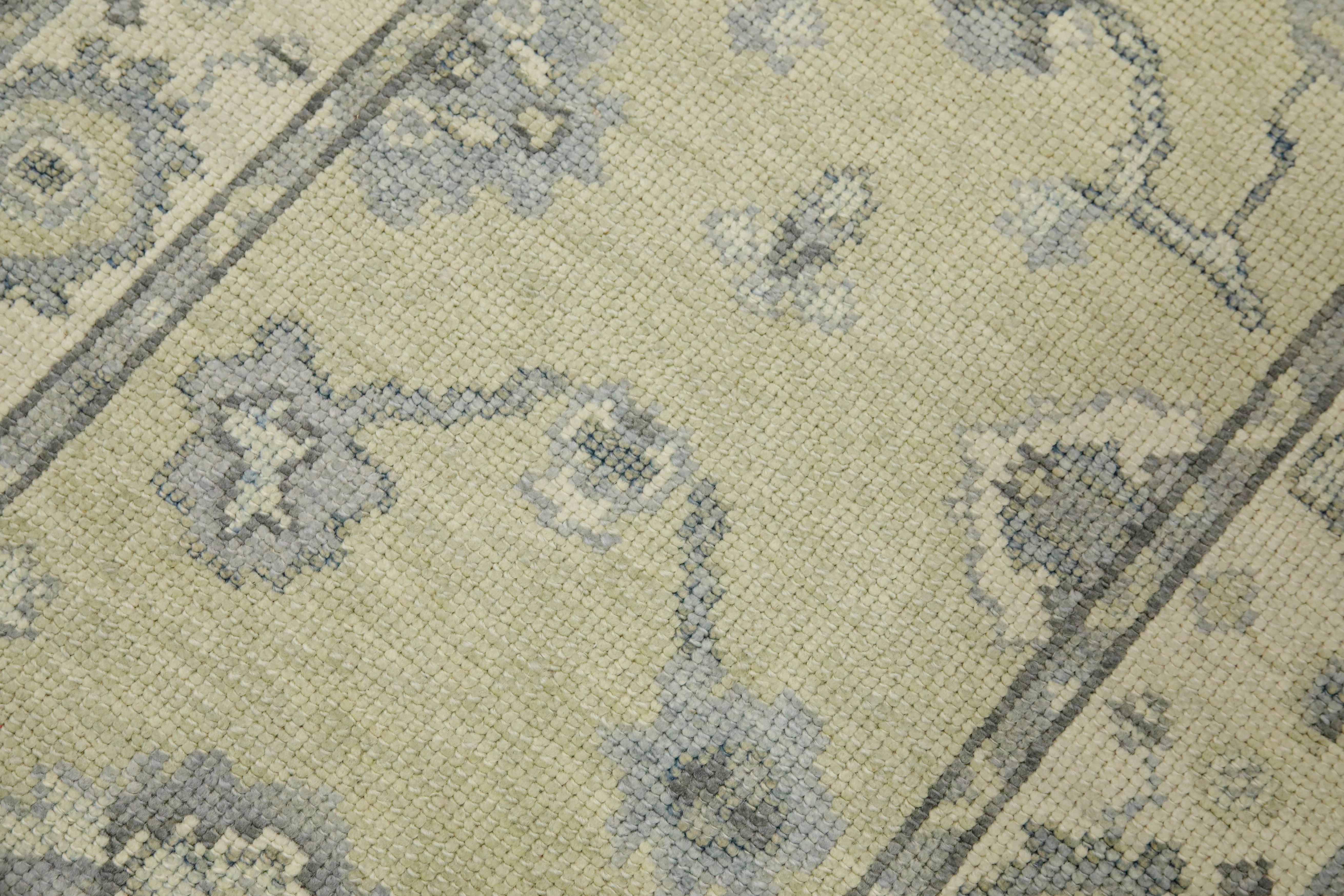 This modern Turkish Oushak rug is a stunning piece of art that has been handwoven using traditional techniques by skilled artisans. The rug features intricate patterns and a soft color palette that is achieved through the use of natural vegetable