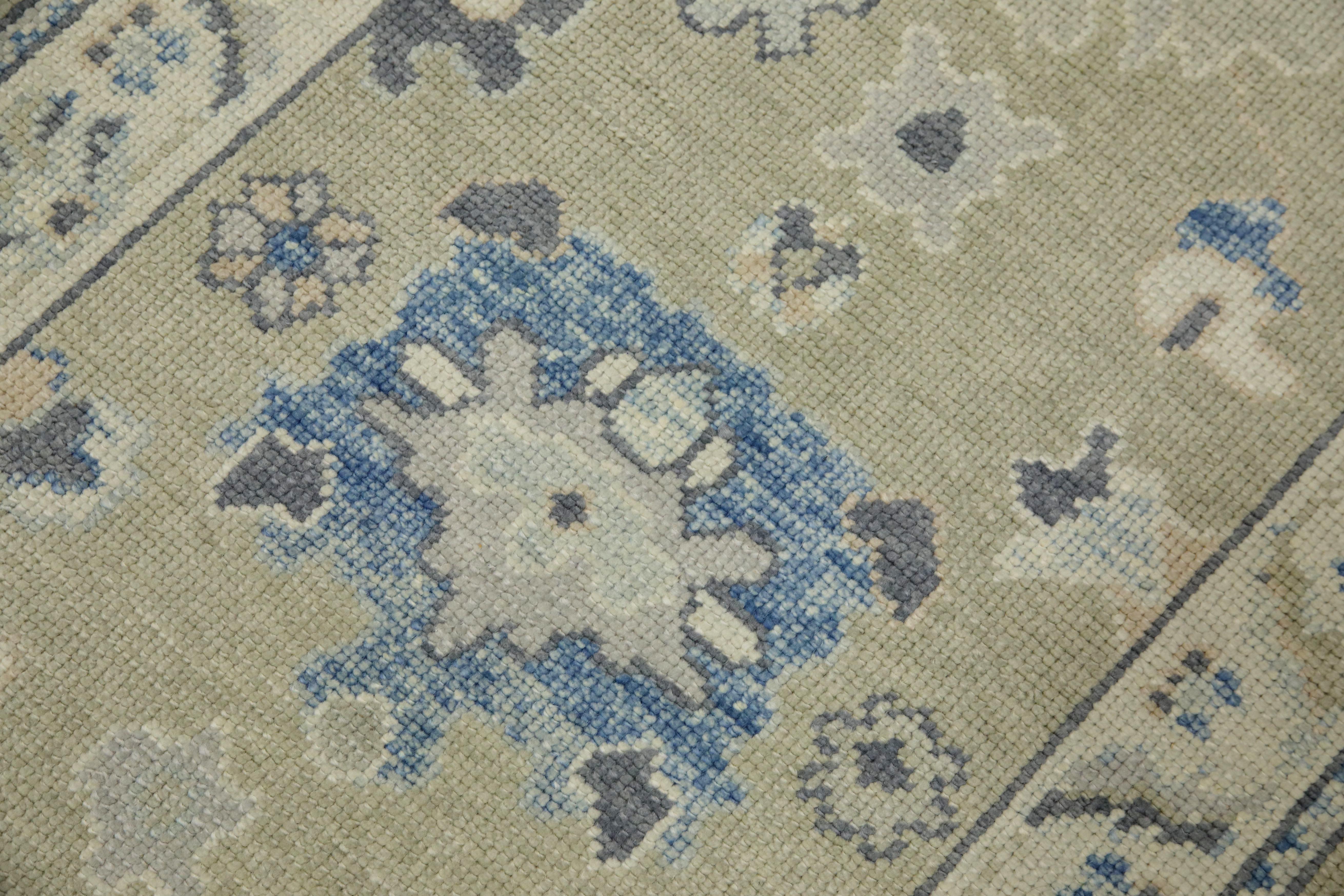 This modern Turkish Oushak rug is a stunning piece of art that has been handwoven using traditional techniques by skilled artisans. The rug features intricate patterns and a soft color palette that is achieved through the use of natural vegetable