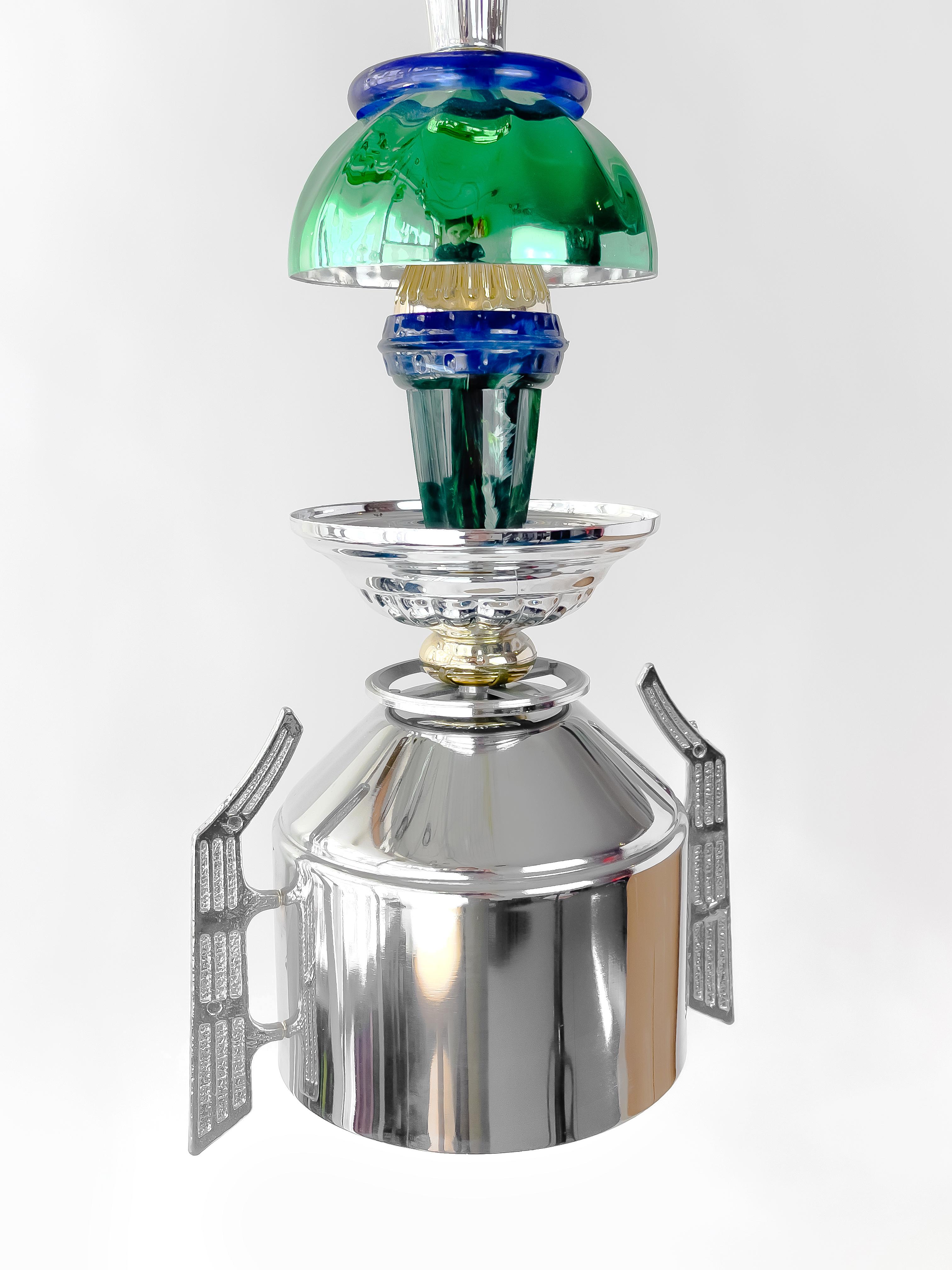 Green, blue L50 Light by Flétta
Dimensions: D 10 x H 53 cm (dimensions are variable)
Cord: 250 cm
Materials: silver, gold

Trophy is a collection of tables, lights, flowerpots and shelves made of old trophies collected from athletes and sports