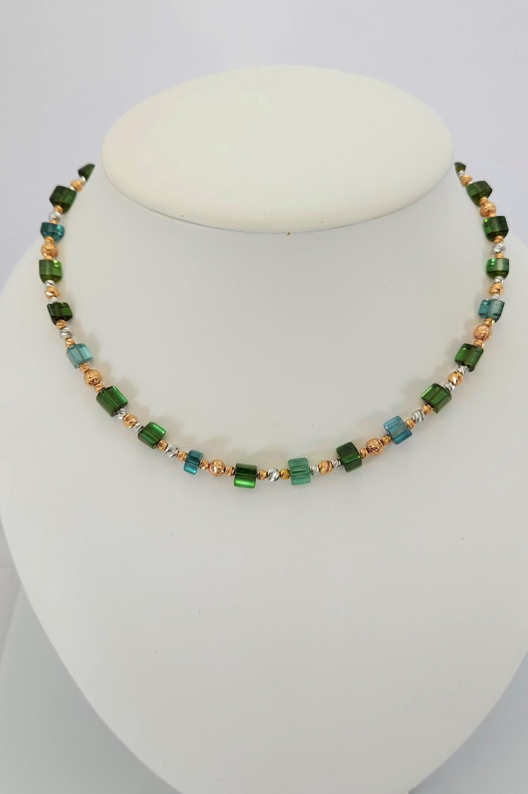 This Natural Green-blue Tourmaline Crystal Beaded Necklace with 18 Carat rose and white Gold is handmade.
Cutting as well as goldwork are made in German quality. The screw clasp is easy to handle and very secure.
Triangular gold clasp matchs