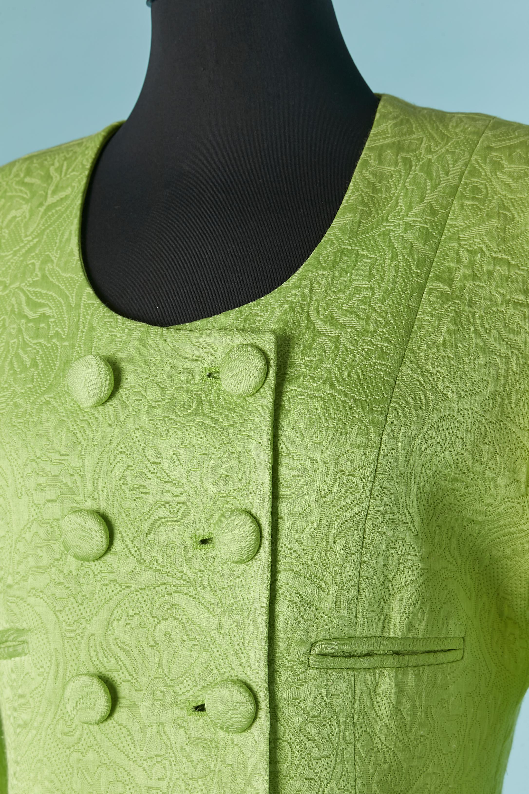 Green brocade skirt-suit. Main fabric composition: 37% cotton, 36% acetate, 27% rayon. No fabric composition for the lining but it's probably rayon or acetate. 
Shoulder pad. Buttons covered with fabric. cut-work. Pocket on both side on the jacket