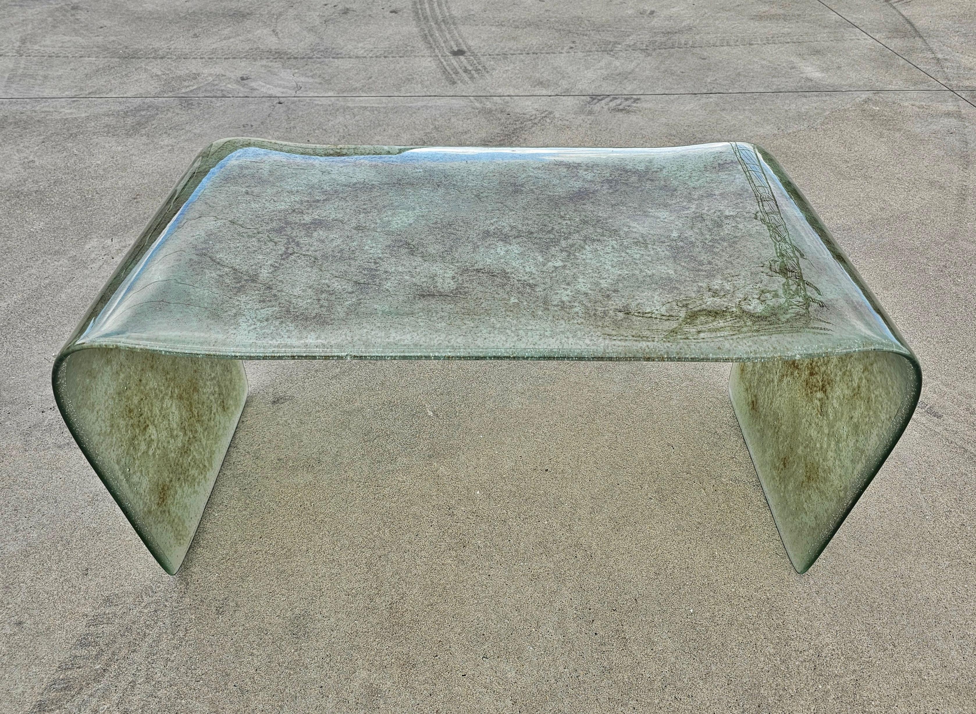 In this listing you will find a gorgeous and very rare Coffee or Sofa Waterfall Table that was handmade of a single piece of solid glass. The green/gray bubble glass features beautiful texture and very elegant uneven, almost organic lines. Table was