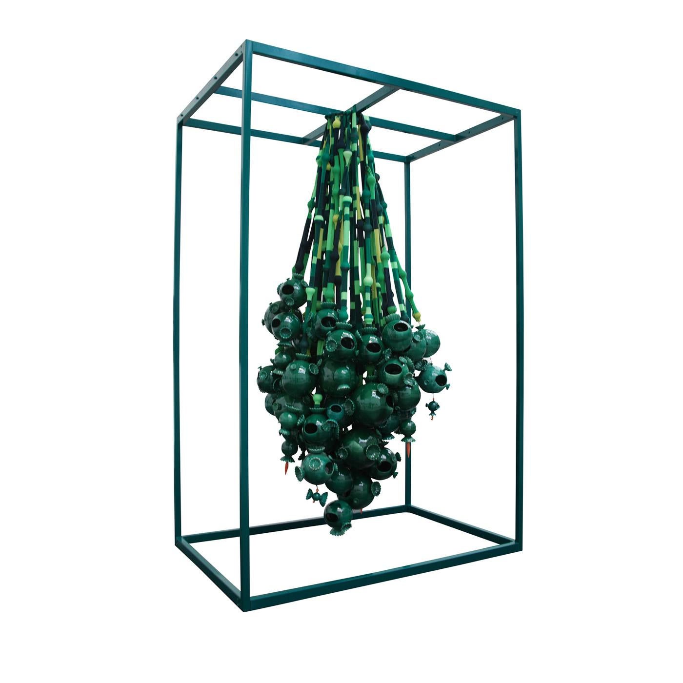 Green glazed ceramic shapes hang in descending spheres of different sizes upon suspended steel cables. Handcrafted flawlessly and customizable, this eccentric design object exemplifies the playful but elegant vision of Roberto Cambi and is suitable