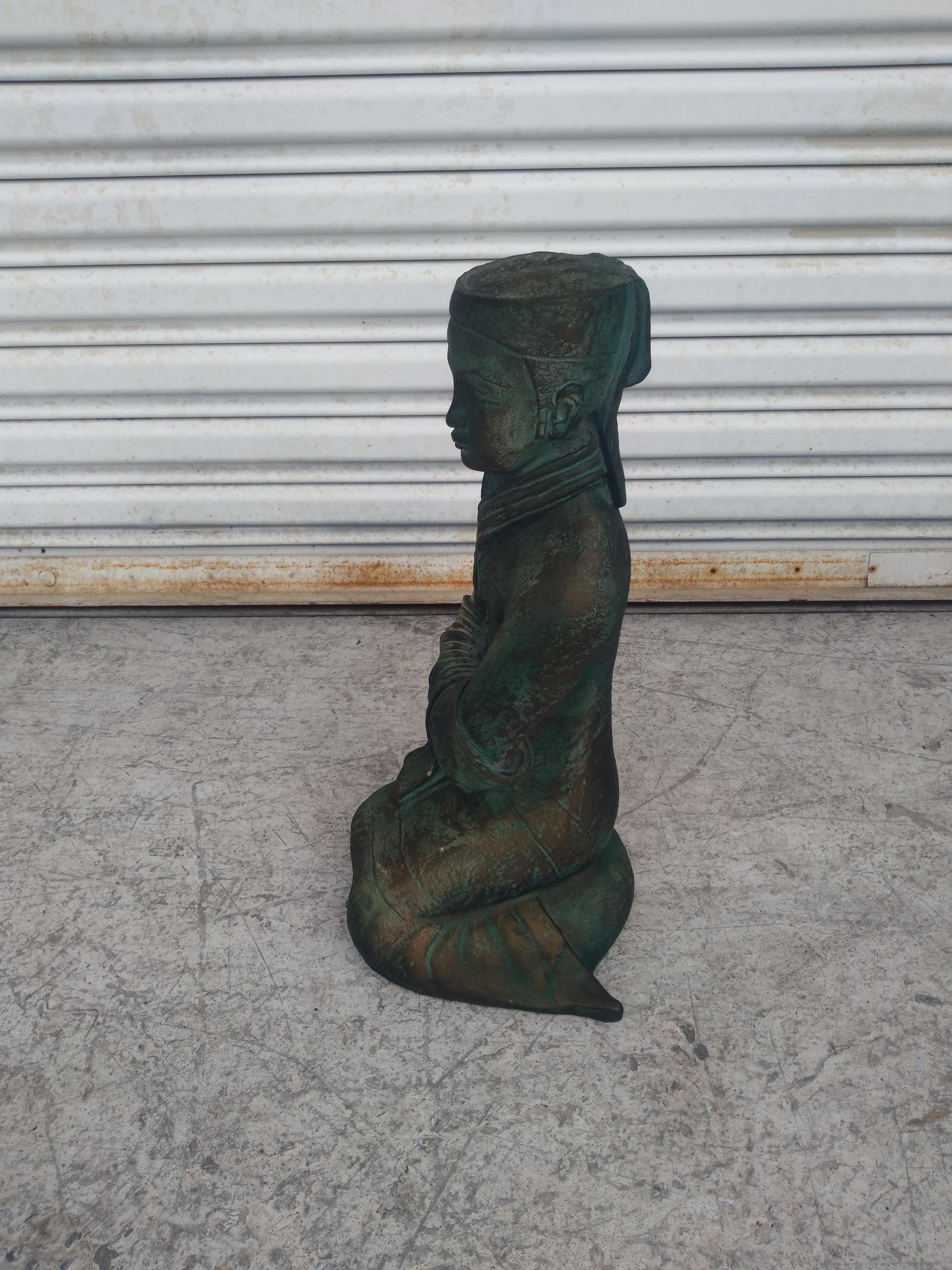 Il s'agit d'une sculpture produite par Austin Studio. Il est fabriqué en durastone. Il est moulé  en a. Moule. Cette pièce représente un bouddha assis. Il est moulé en durastone vert.