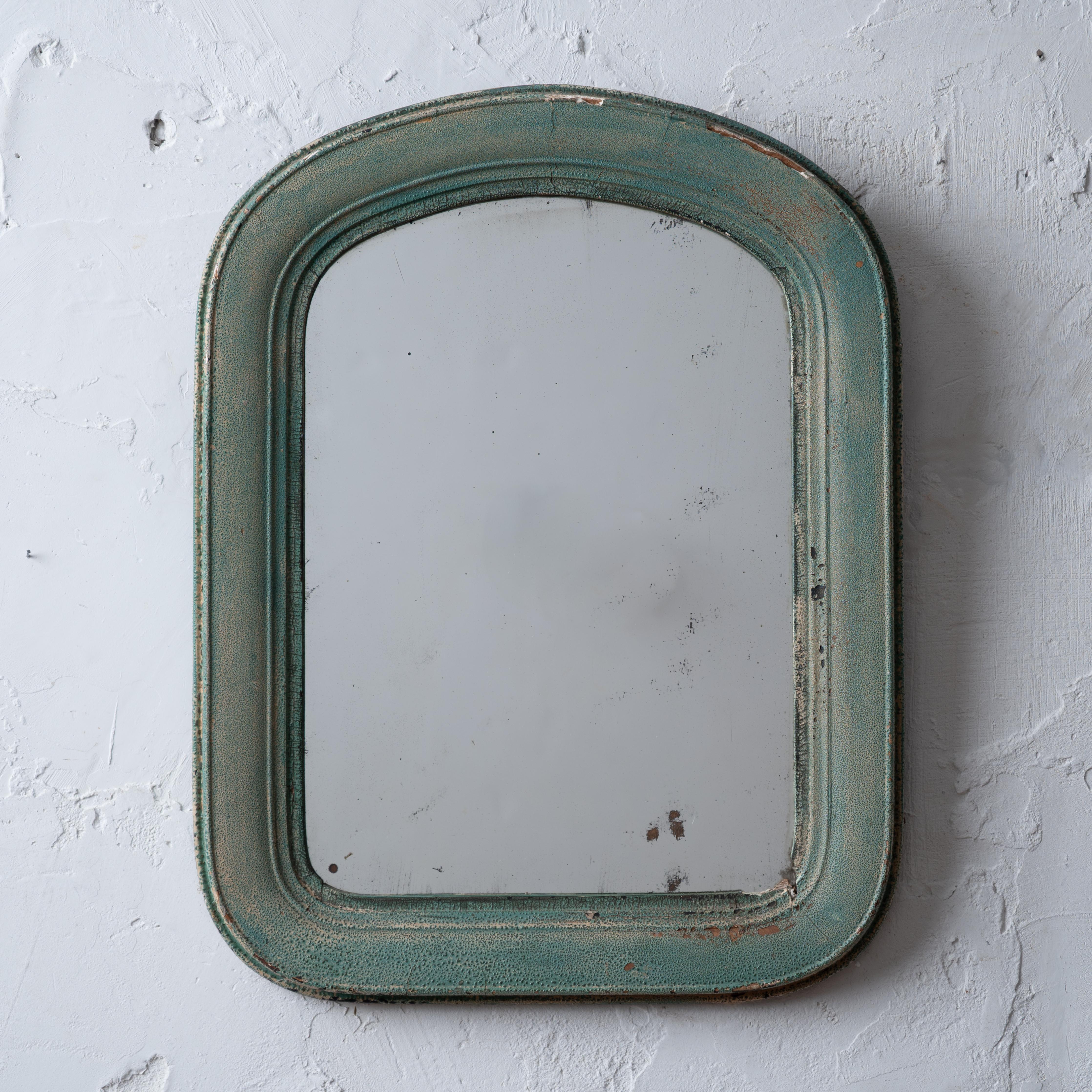 A green butler’s blown glass mirror, circa 1870.



13 ¾ inches wide by 17 ¾ inches tall by 1 inch deep.



