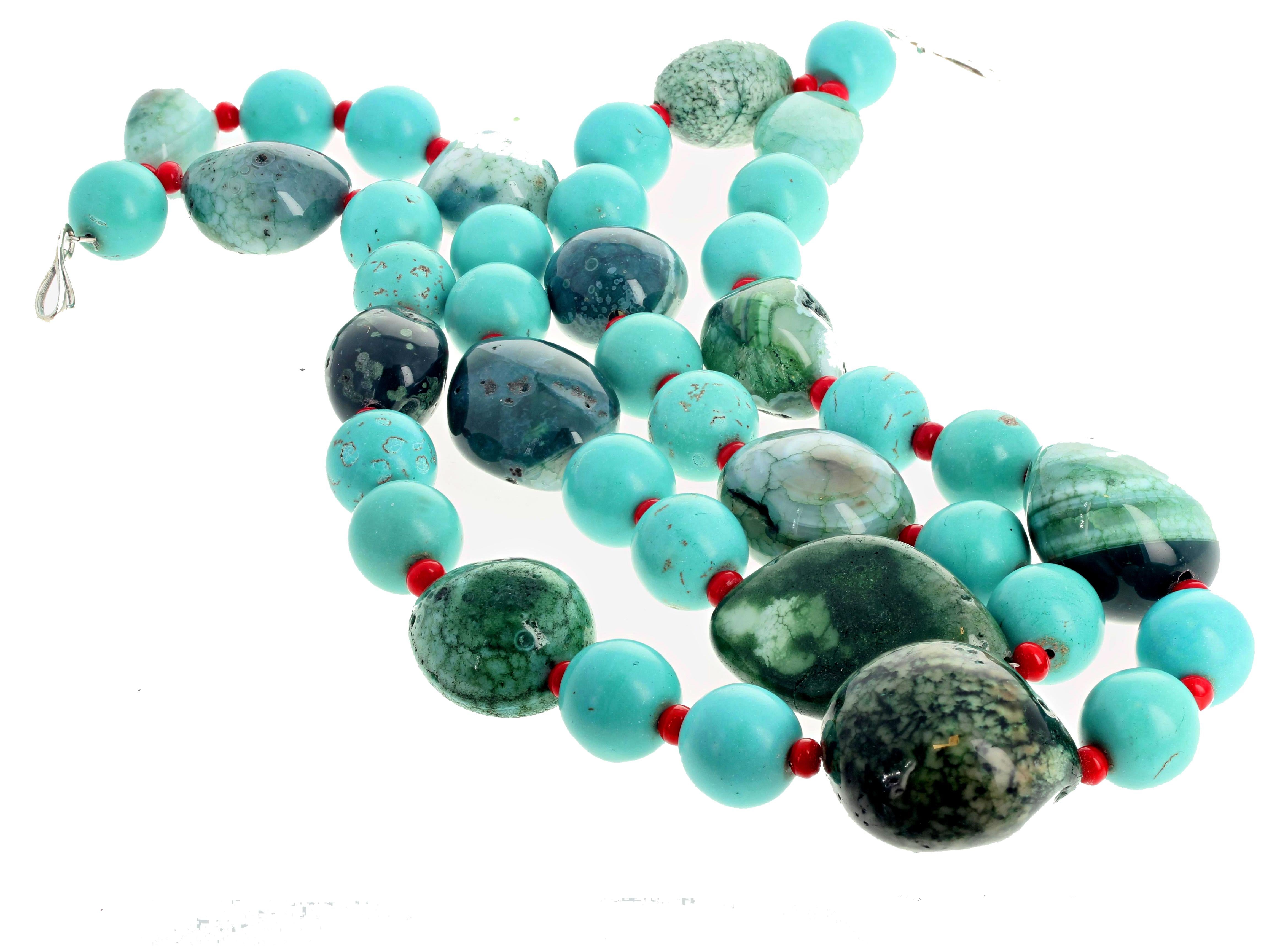 Artistic looking large chunks of highly polished blue and green Canadian Jade enhanced with blue Turquoise rondels and accented with small rondels of red Coral in this double strand 20 inch long necklace with sterling silver clasp.  More from this