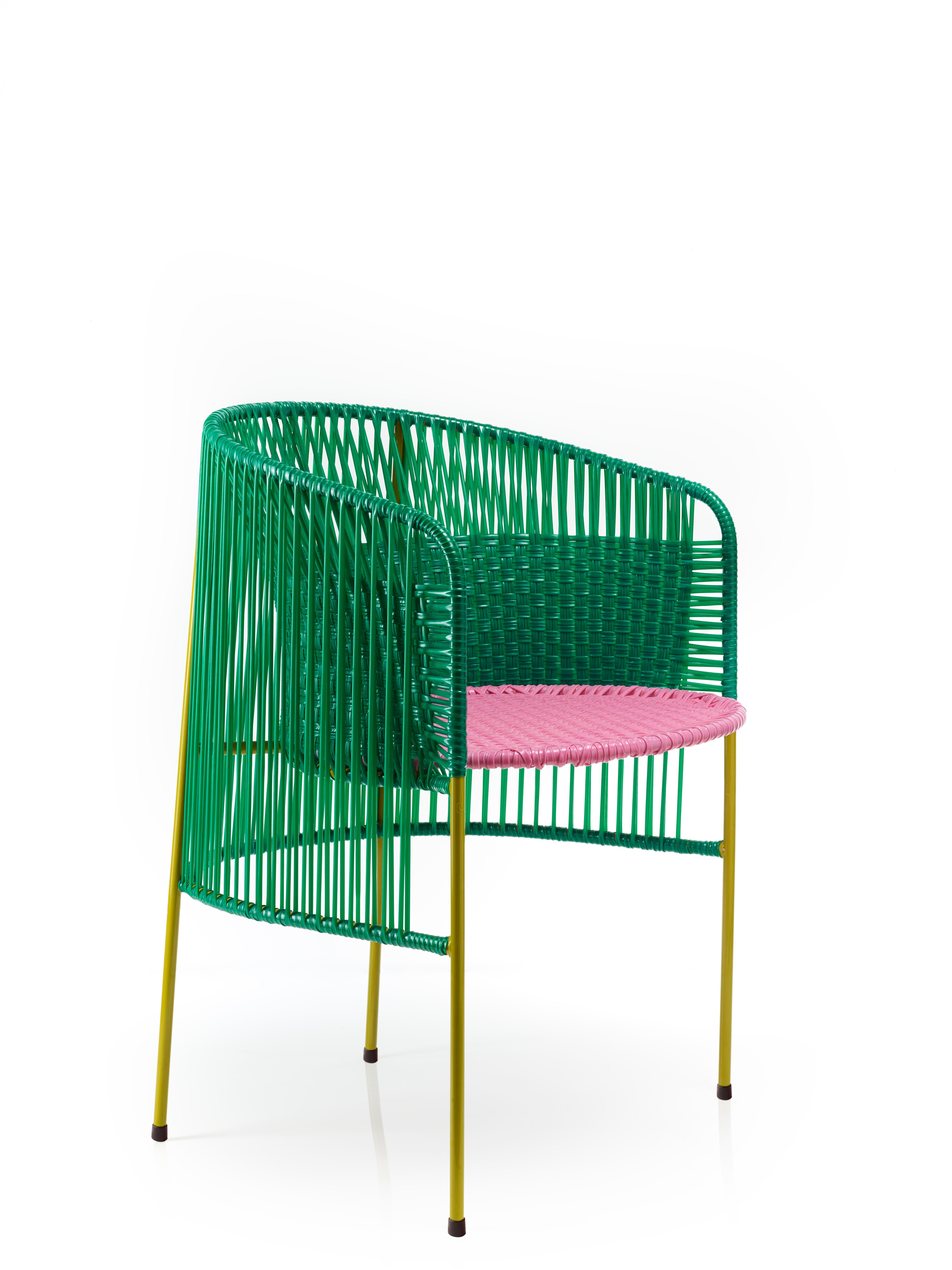 Green caribe dining chair by Sebastian Herkner
Materials: Galvanized and powder-coated tubular steel. PVC strings are made from recycled plastic.
Technique: Made from recycled plastic and weaved by local craftspeople in Colombia. 
Dimensions: W