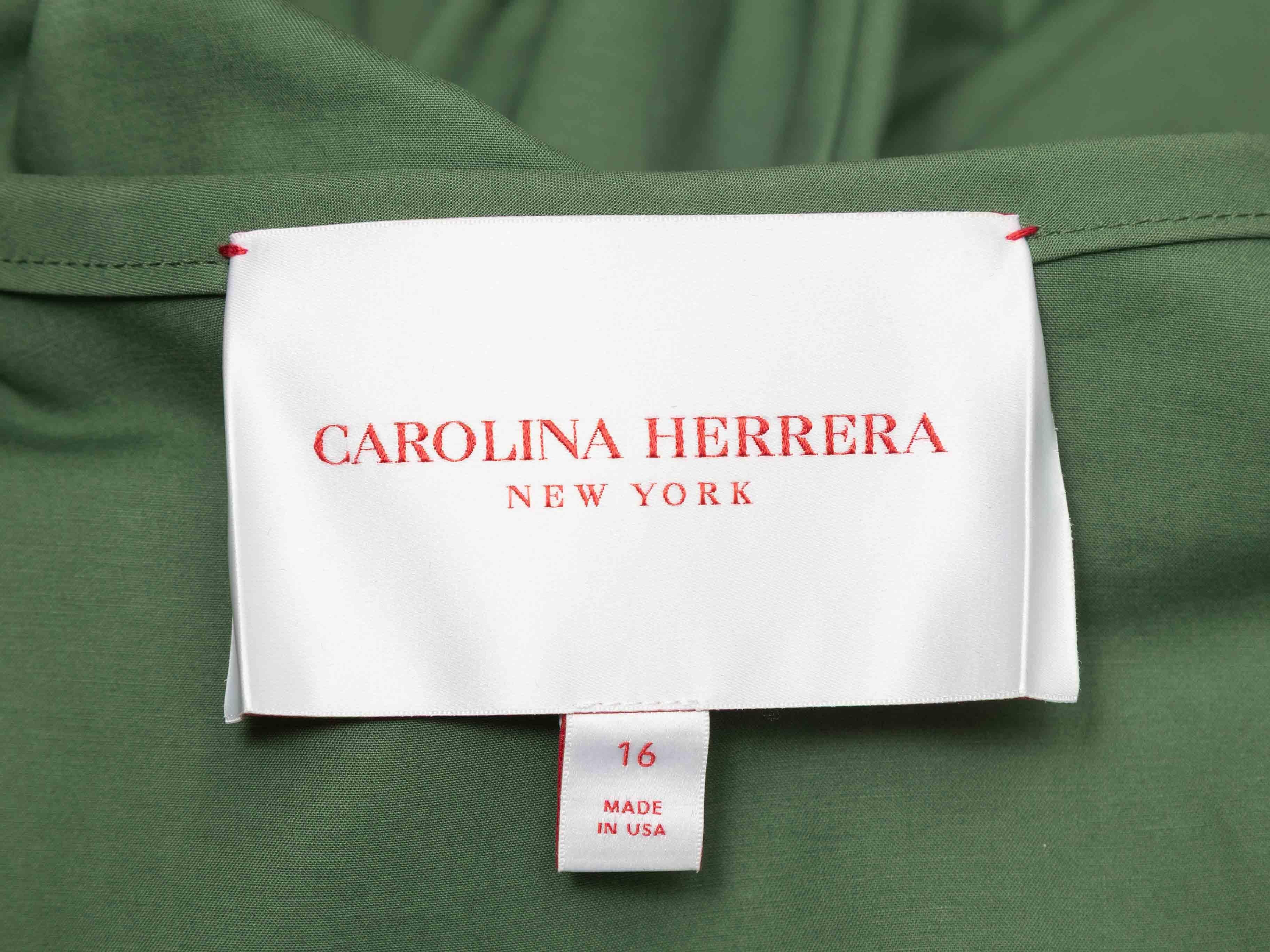 Green long sleeve button-up dress by Carolina Herrera. Crew neck. Four pockets. Button closures at center front. 48