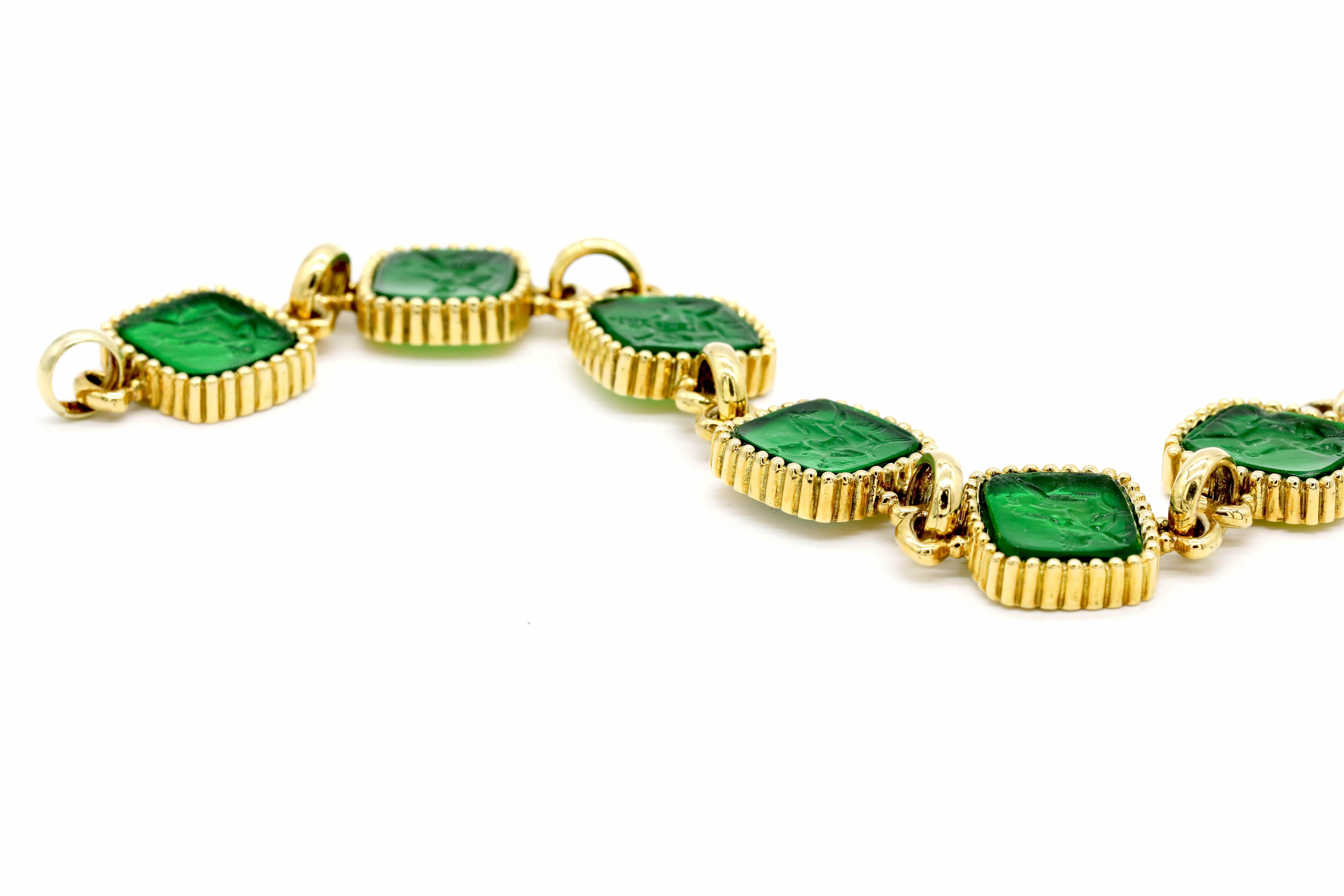 New Victorian Green Carved Italian Murano Glass Carved Intaglio Bracelet 18k Yellow Gold

A cameo, an intaglio is created by carving below the surface to produce an image in relief, with the purpose of pressing into sealing wax. Intaglios were often