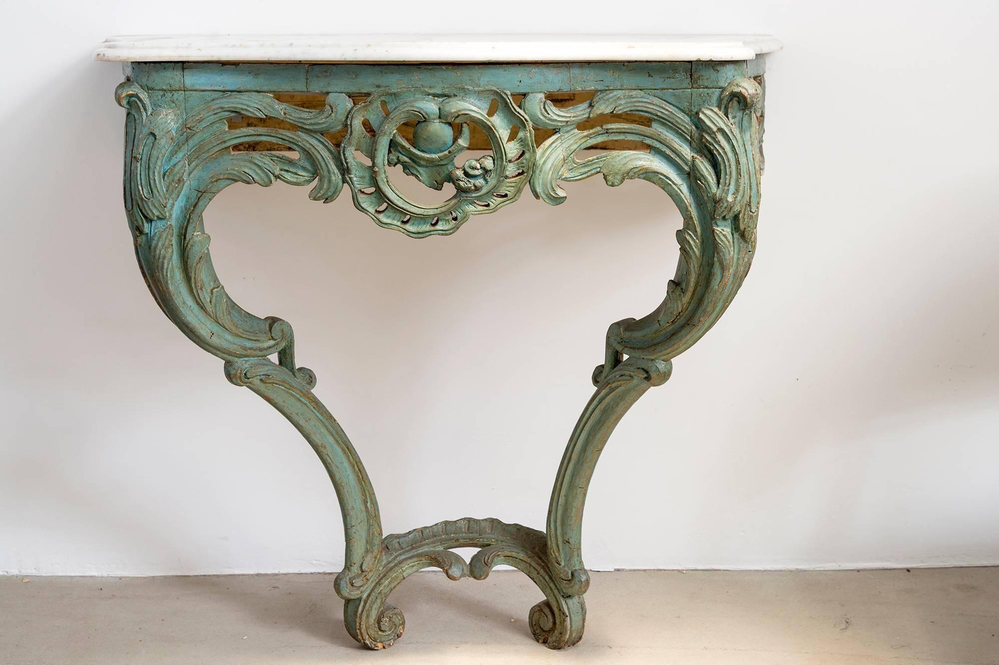 A beautiful patina green carved wooden console table with white marble top from France, 1875. Intricate carving and scalloped, rounded edges of this console make it a lovely addition to any room of distinction.