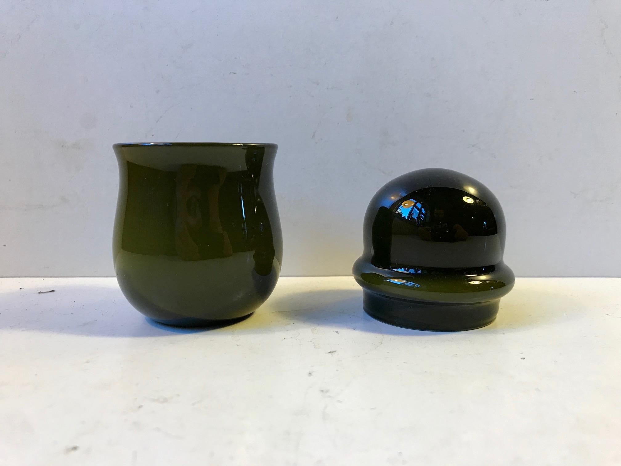 A rare lidded jar or pill glass in cased Opaline and avocado green glass. Designed by Michael Bang in 1976 and manufactured by Holmegaard in Denmark for a few years. Its probably the rarest part within the Palet series from Bang. The condition is