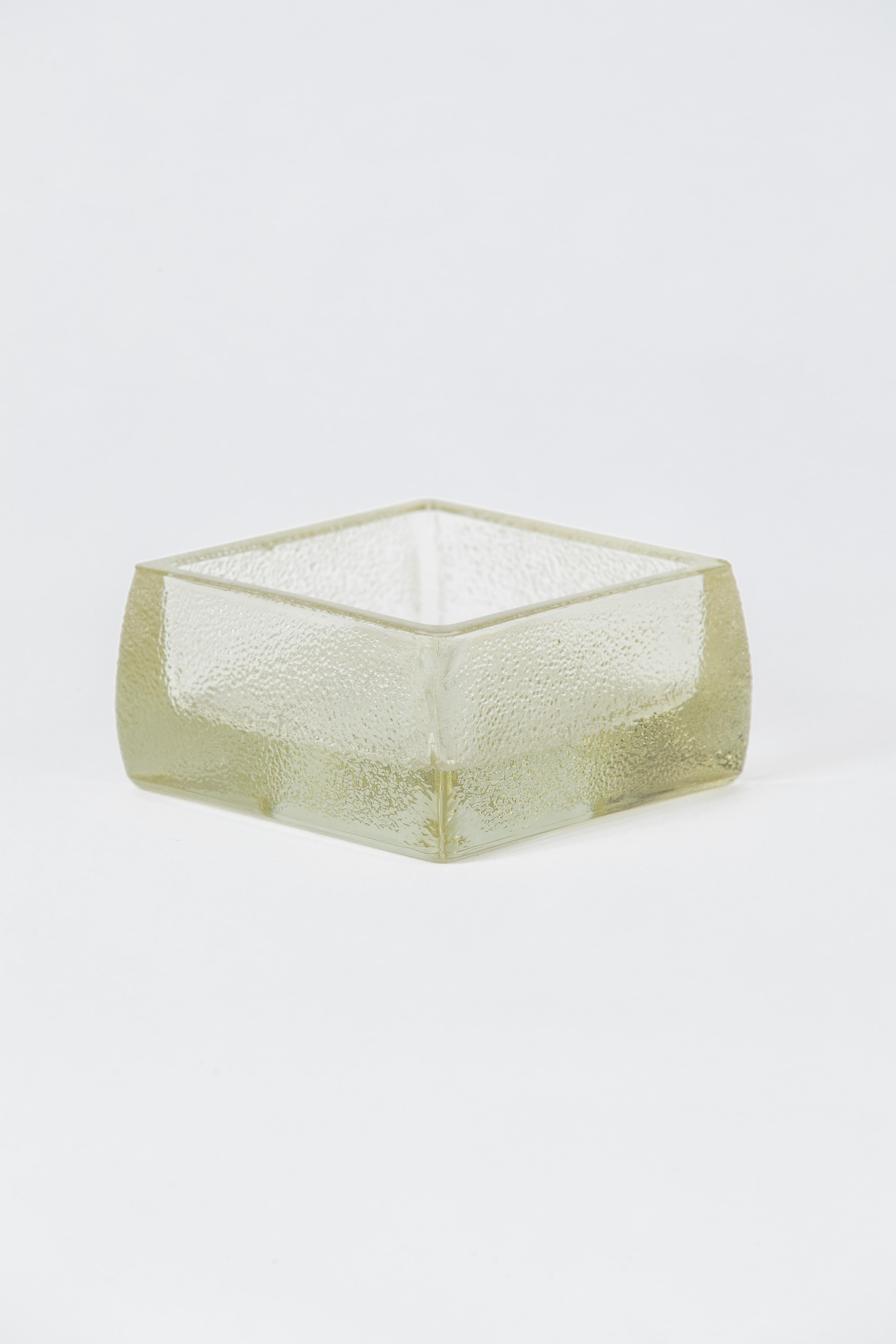 A heavy cast glass by French maker Lumax, supplier glass to everyone from Corbusier to Adnet. You can see their work in examples of architecture from the period as well as in leather-wrapped objects by Adnet.