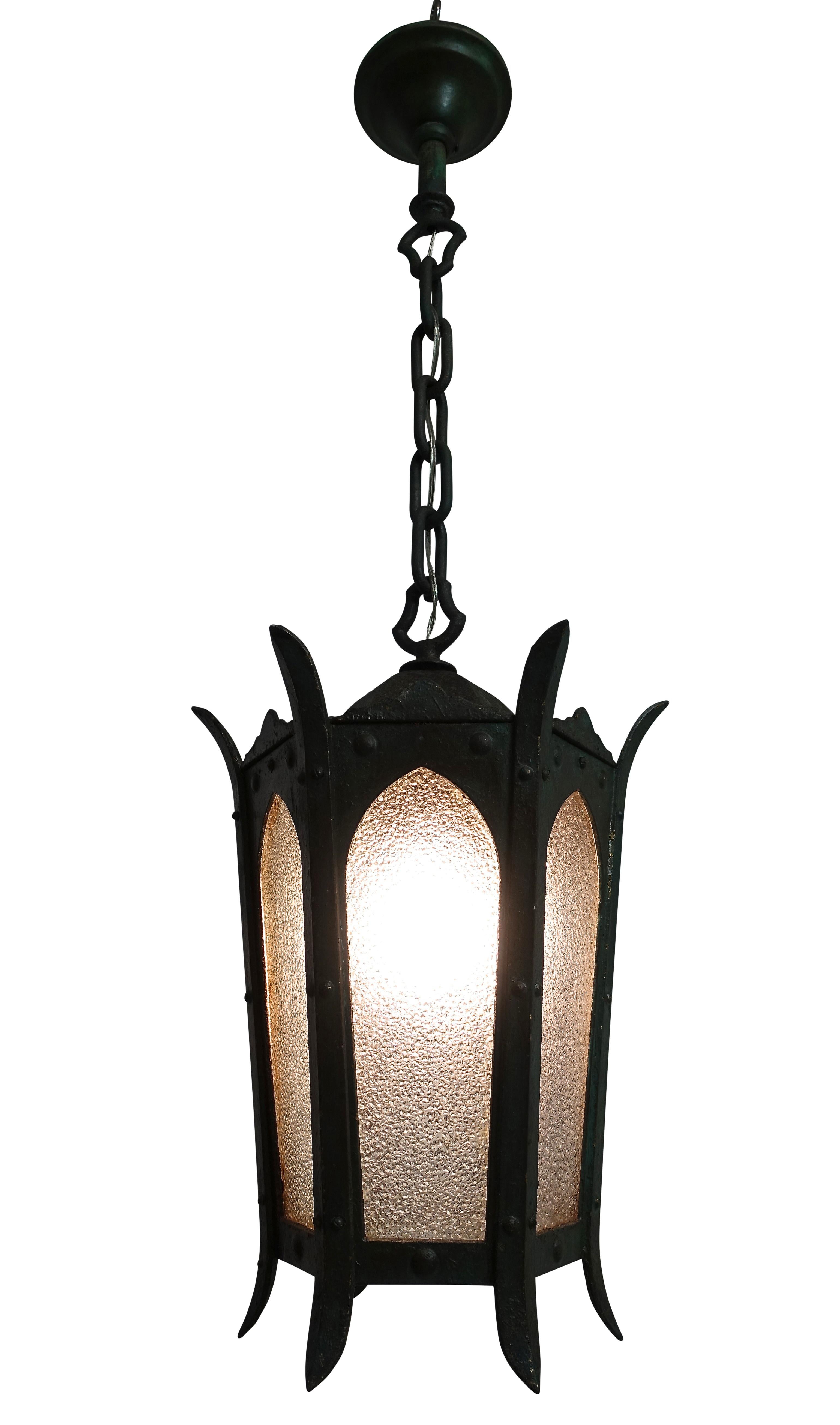 A vintage cast iron and metal lantern with weathered green paint, opaque textured glass panels and patinated canopy. Chain can be shortened to desired length. Recently re-wired, holds a single standard size light bulb.