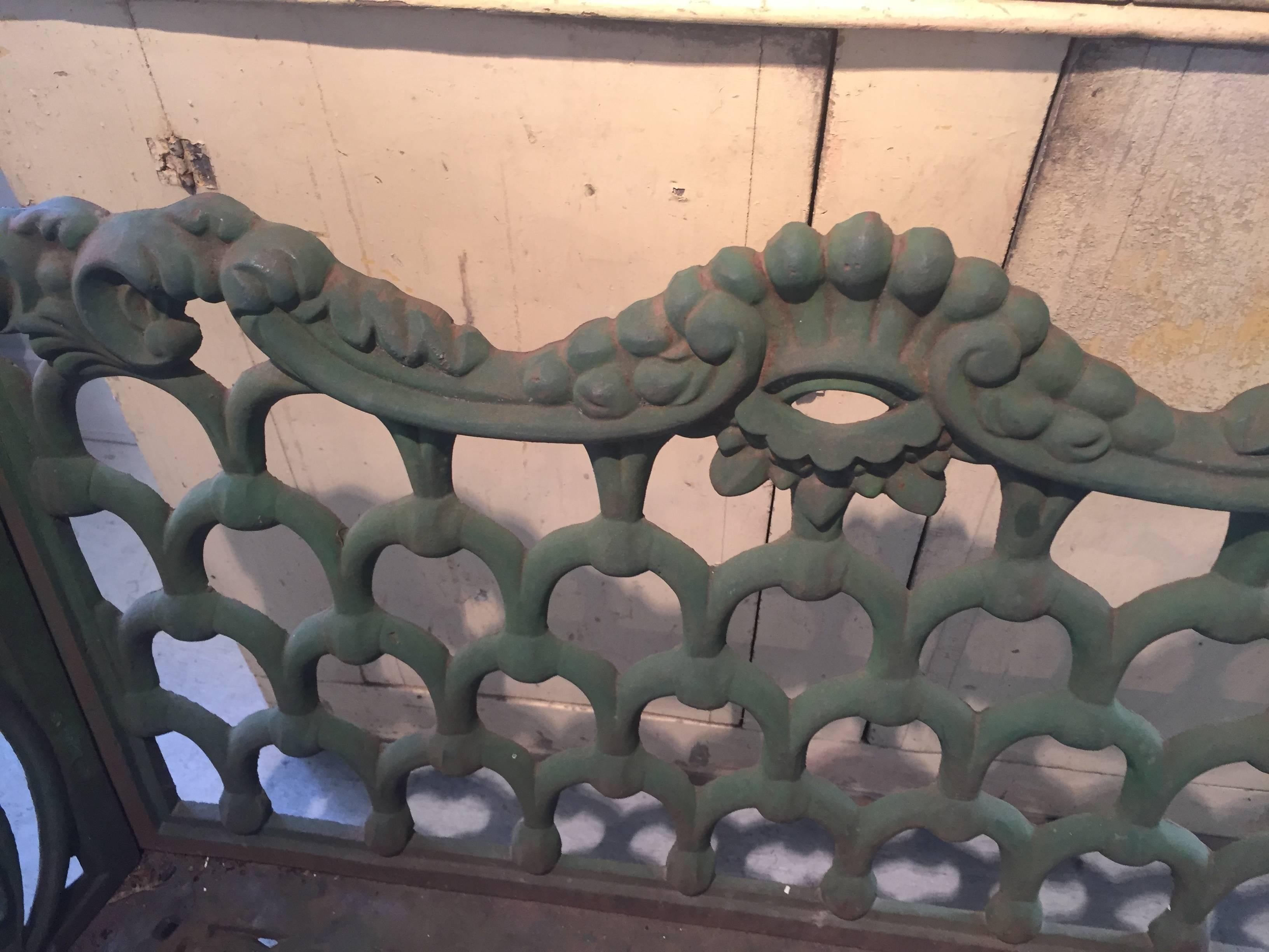 Green painted cast iron garden bench. Rare form and iron work design. Two seat, original paint.