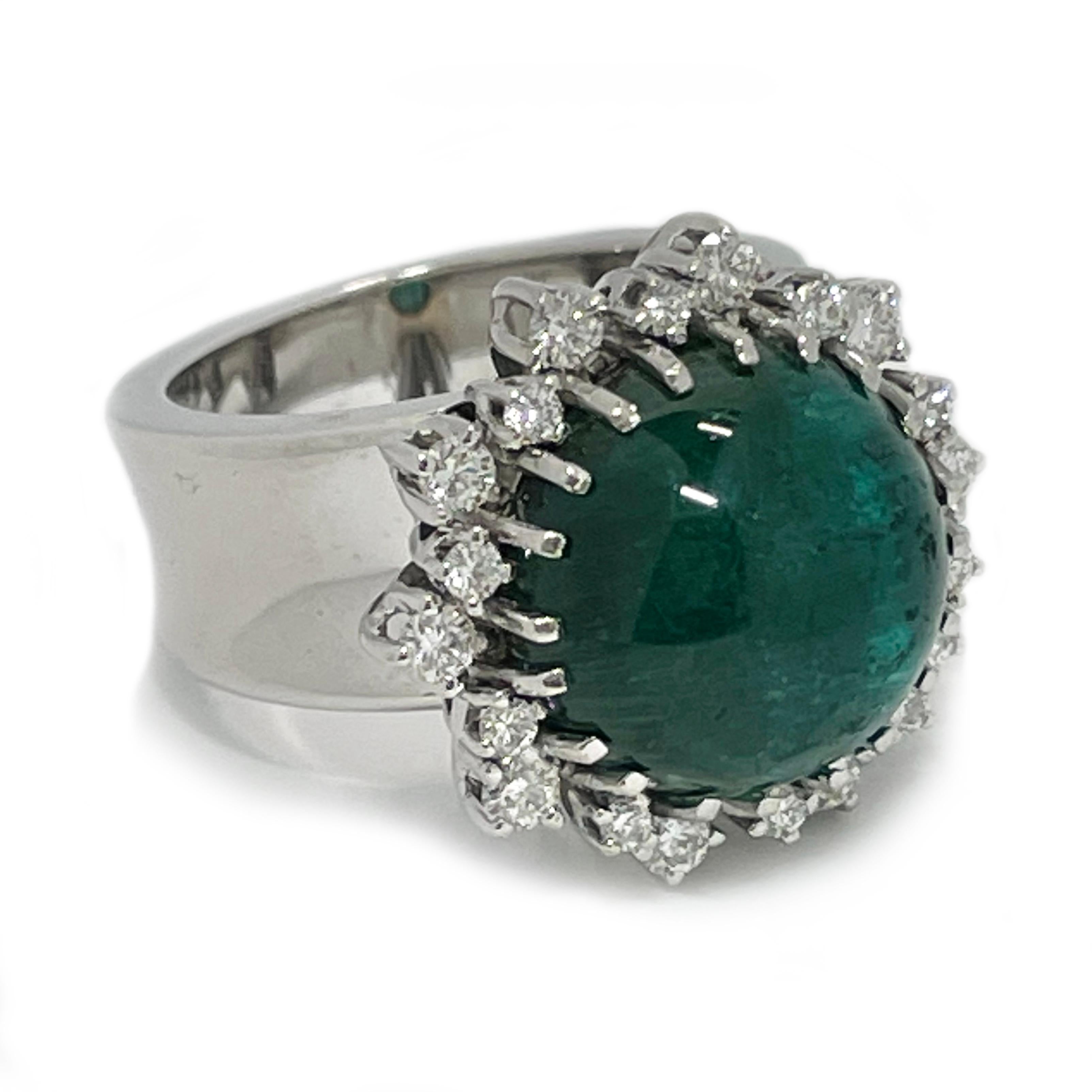 14 Karat Round Cat’s Eye Green Tourmaline Diamond Cocktail Ring. The Green Tourmaline is 14mm and has a  carat weight of 12.20ct. The beautiful green hued stone is prong-set against 14k white gold. Prominent single band cat's eye when light hits the