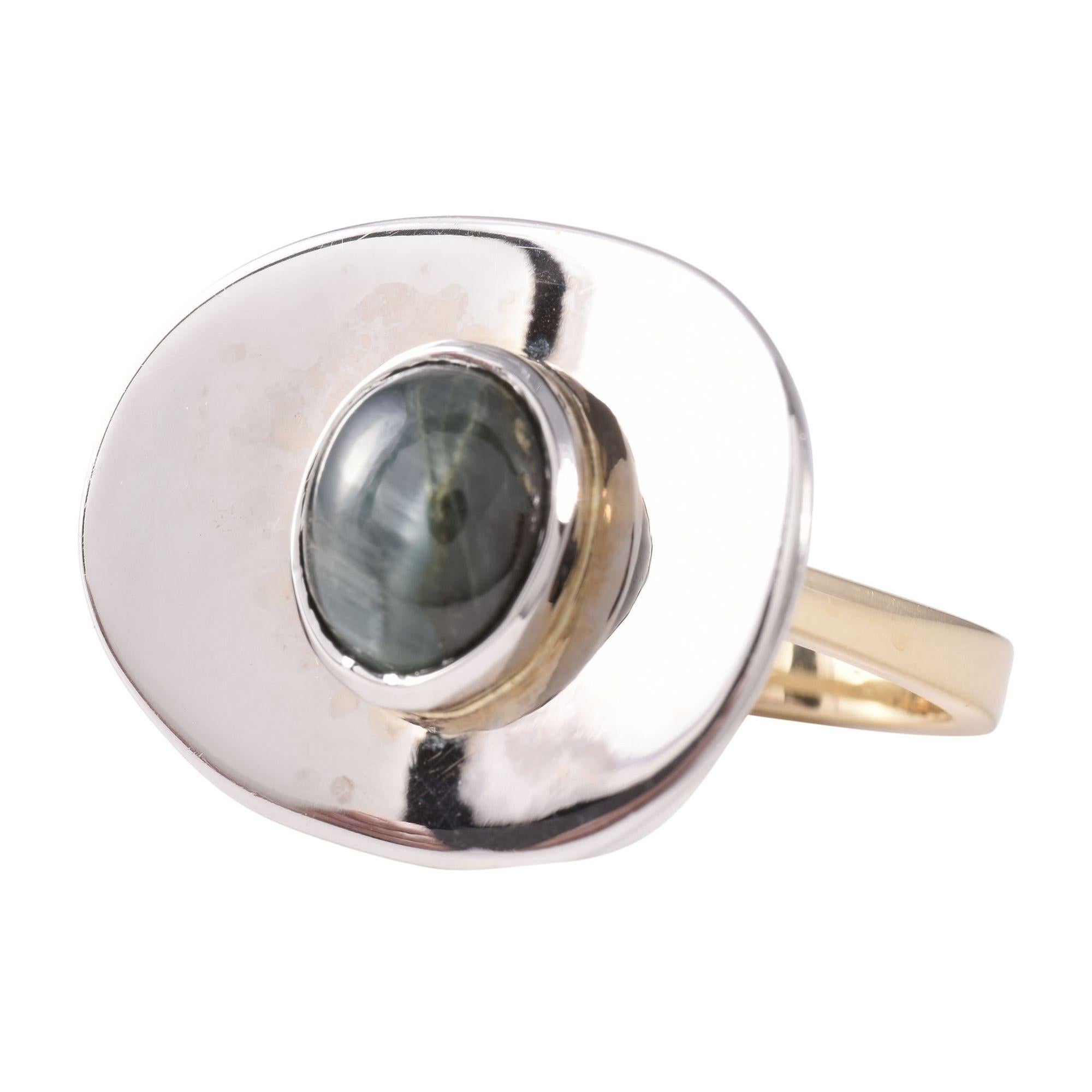 Estate green cats eye tourmaline two tone gold ring. This 14 karat white and yellow gold ring features a green cats eye tourmaline. The cats eye ring is a size 5.75. [KIMH 2139 P]

*Resizing available for additional charge.