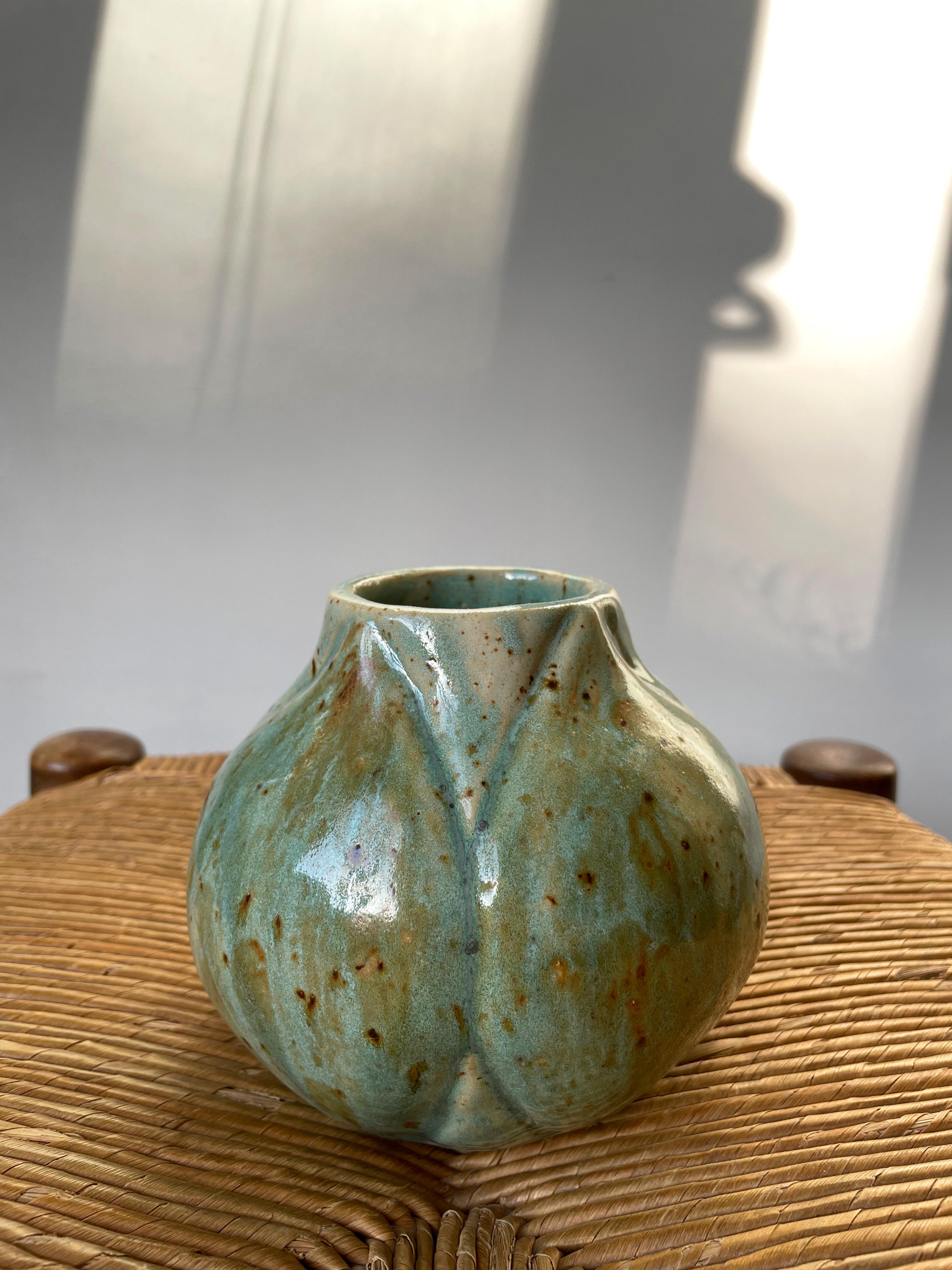 Handmade Danish organic modern ceramic stoneware plump artichoke shaped vase. Green, caramel brown speckled glaze. Signed under base. Beautiful vintage condition.
Denmark, 1990. 