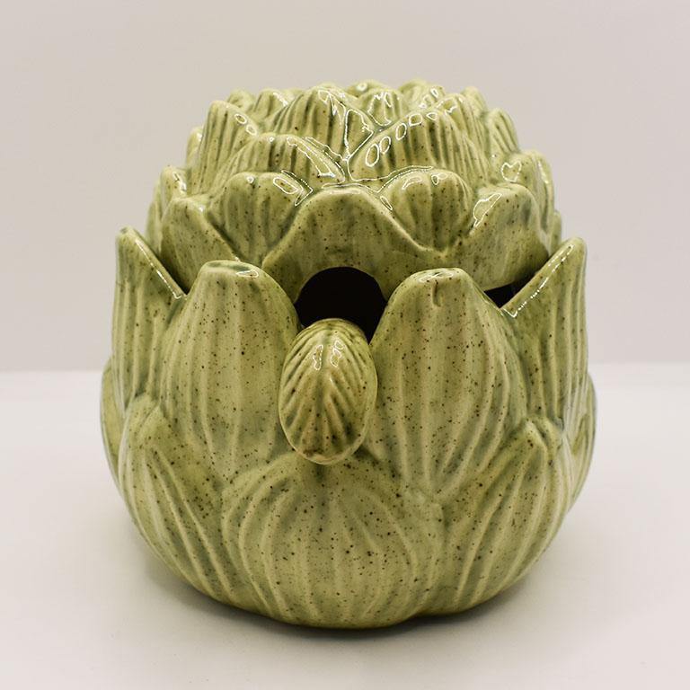 A fun accent to any table, this small ceramic artichoke sugar bowl will make morning coffee the best part of your day. Glazed in a pretty green, the bottom and lid are molded to resemble an artichoke. Remove the lid, and a matching spoon makes