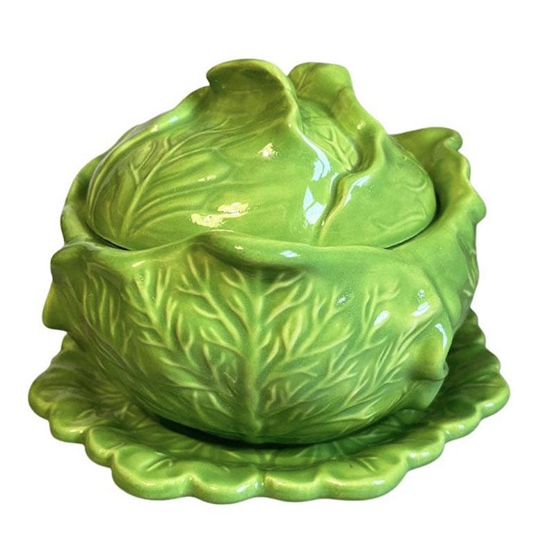 A bright green cabbage motif tureen with lid and underplate. Cabbageware became popular in the 1970s and has become highly collectible for Palm Beach enthusiasts. This iconic piece will be a great accent for your next dinner party. Slightly larger
