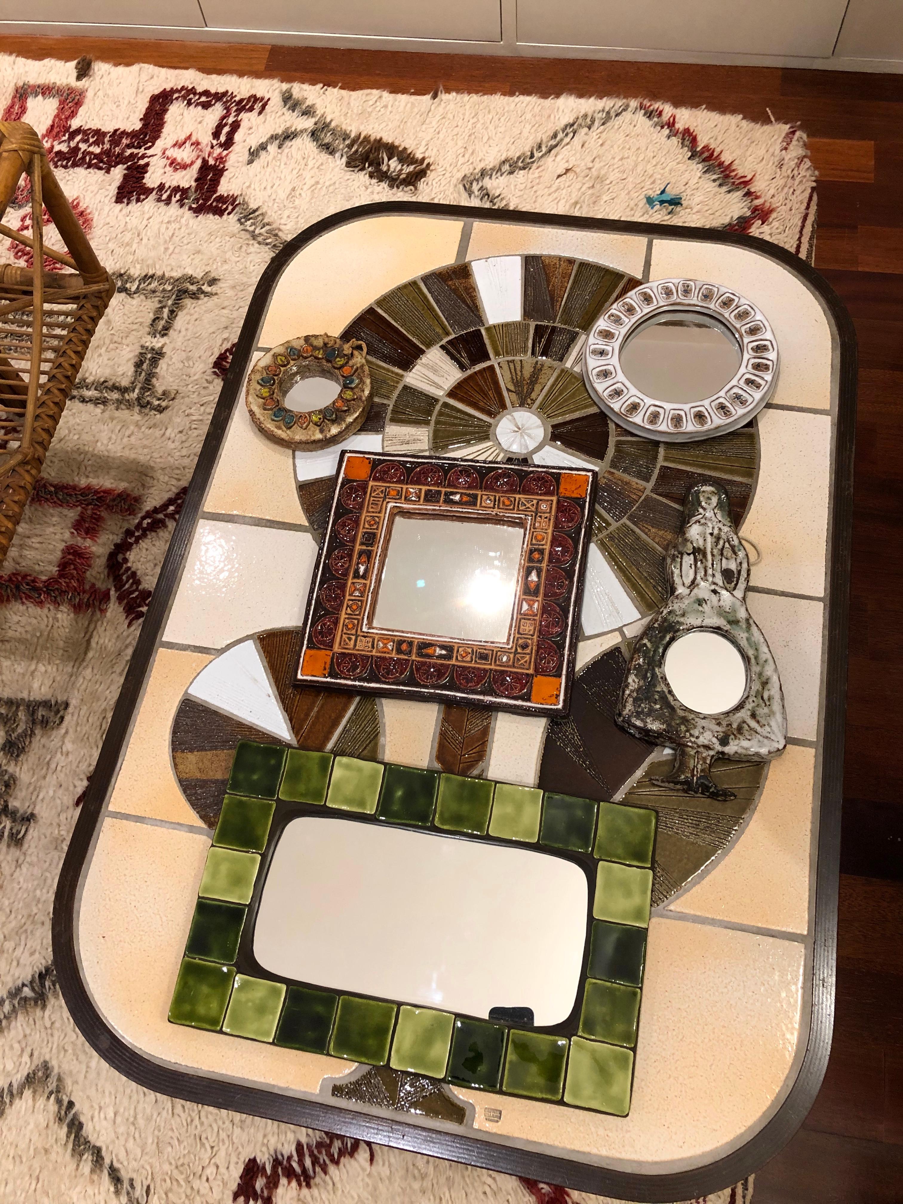 Ceramic tiled French mirror, circa 1970s. Glazed ceramic tiles of alternating dark and light greens frame this rectangular mirror on a ceramic base. A characterful example of its era, this mirror will be a real conversation piece for your home or