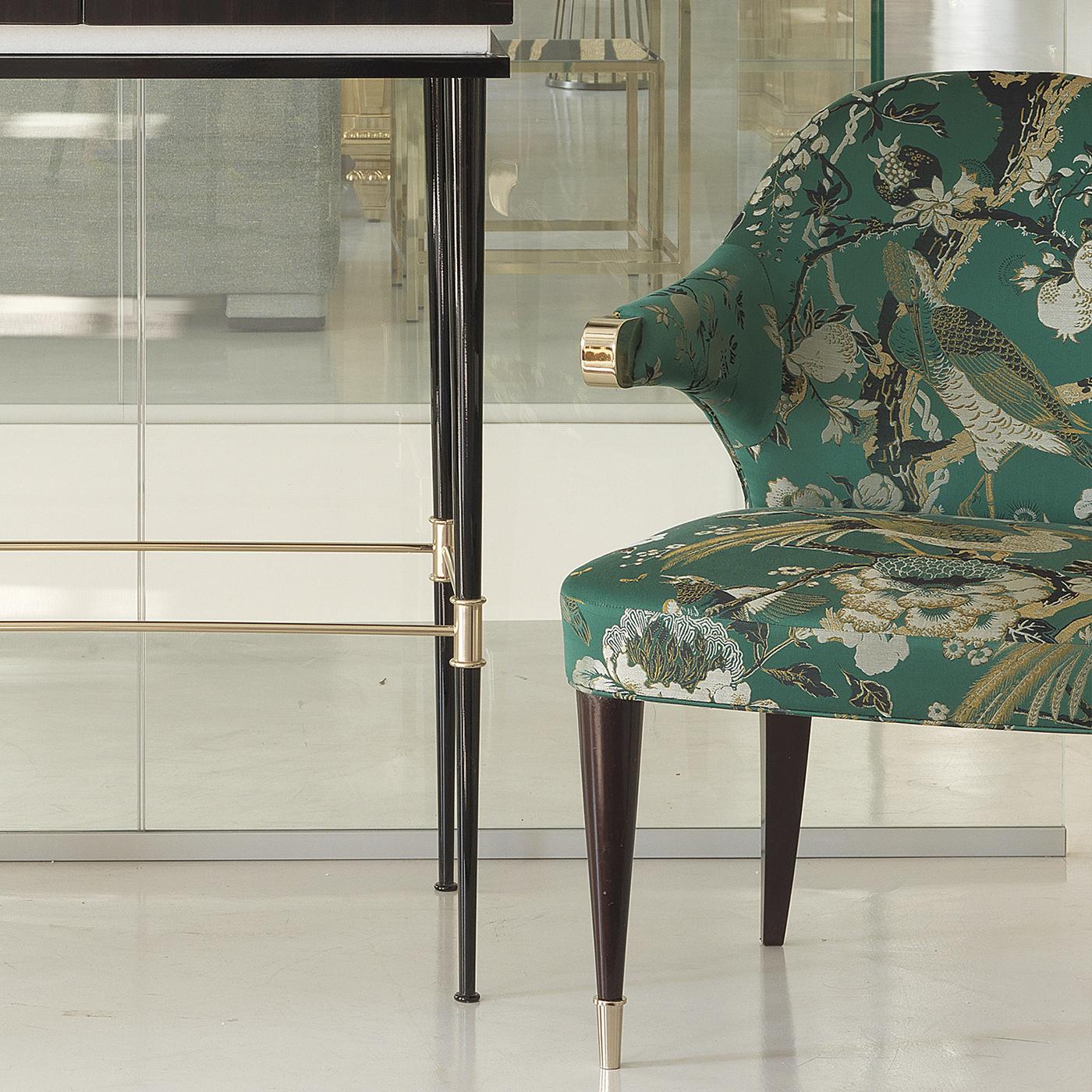 The unique silhouette of this stunning chair will enliven the look of any home. Either used as accent piece in an entryway or bedroom, or to add extra seat to a living room or dining room, while also giving it a sophisticated accent, this chair will