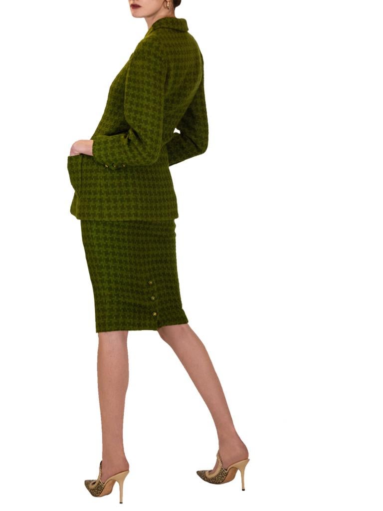 A 1995 Autumn Collection Chanel mantis- and avocado-green dog tooth loosely woven wool suit, the elongated fitted panel jacket with small notched collar and revers, two-piece set-in sleeves with opening, one welt breast pocket and two patch pockets,