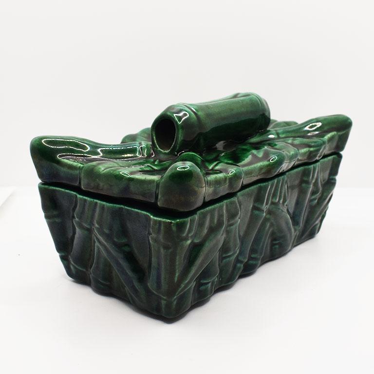 A beautiful rectangular deep green ceramic decorative box with a lid. This ceramic beauty is painted and glazed in a rich green. It is decorated in faux bamboo on both the base and lid. This fun chinoiserie box will make a fantastic focal point on a