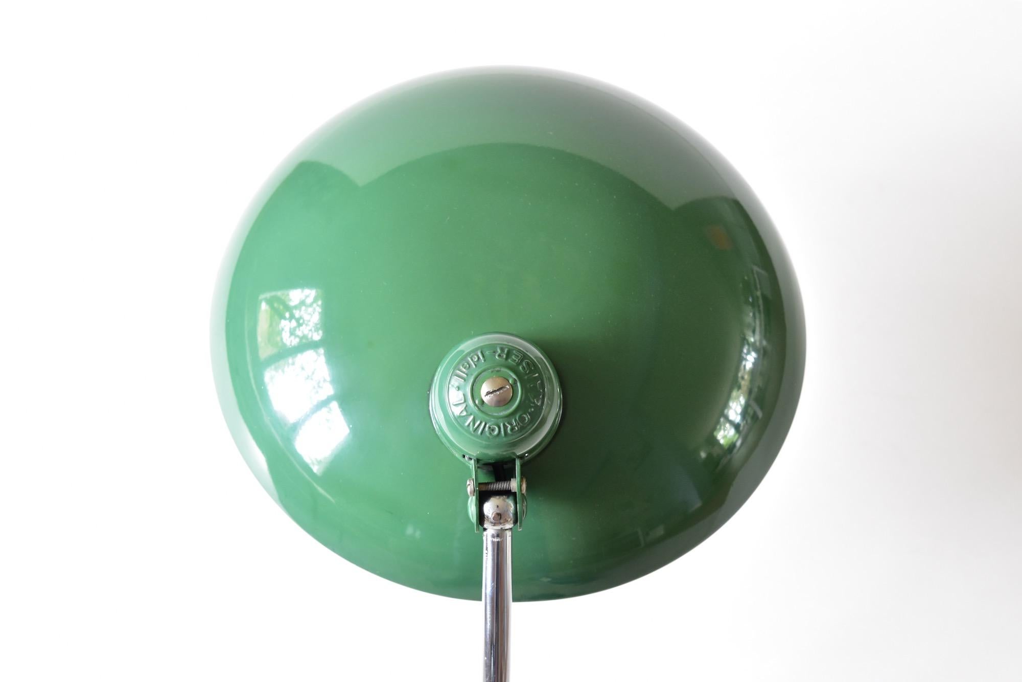 Original green Christian dell desk lamp model 6631 Luxus / president for Kaiser Idell, Germany. Arm and shade adjustable. With E26/27 Edison screw socket. Very nice condition and ready to use with 110 and 250V.
 