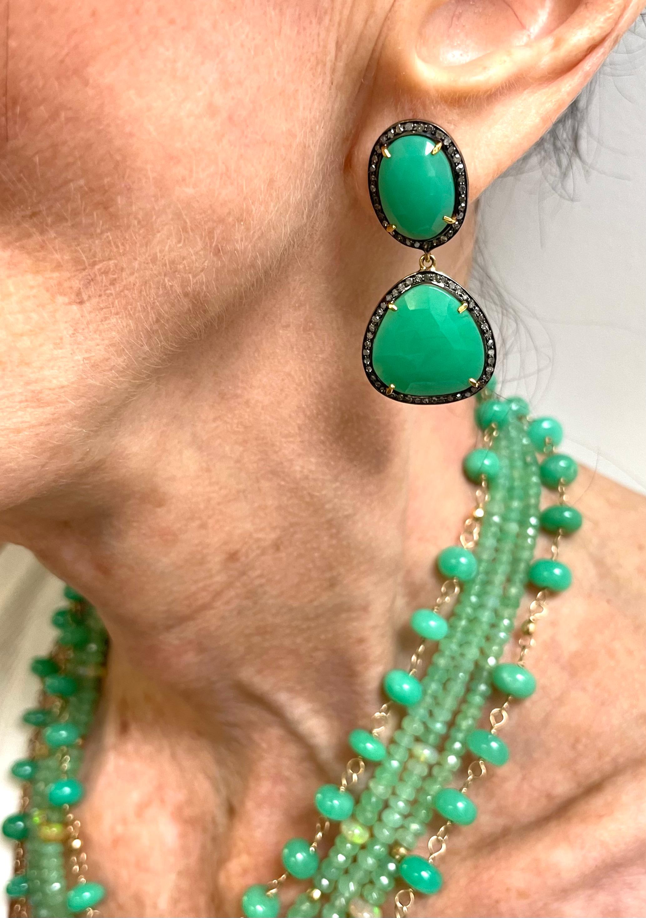 Description
Vivid green faceted Chrysoprase surrounded with pave diamonds in a contrasting black rhodium frame sets off the green, giving the earrings and edgy modern look.
Item #E2422 
For a complete look pair it with a matching necklace (Item #