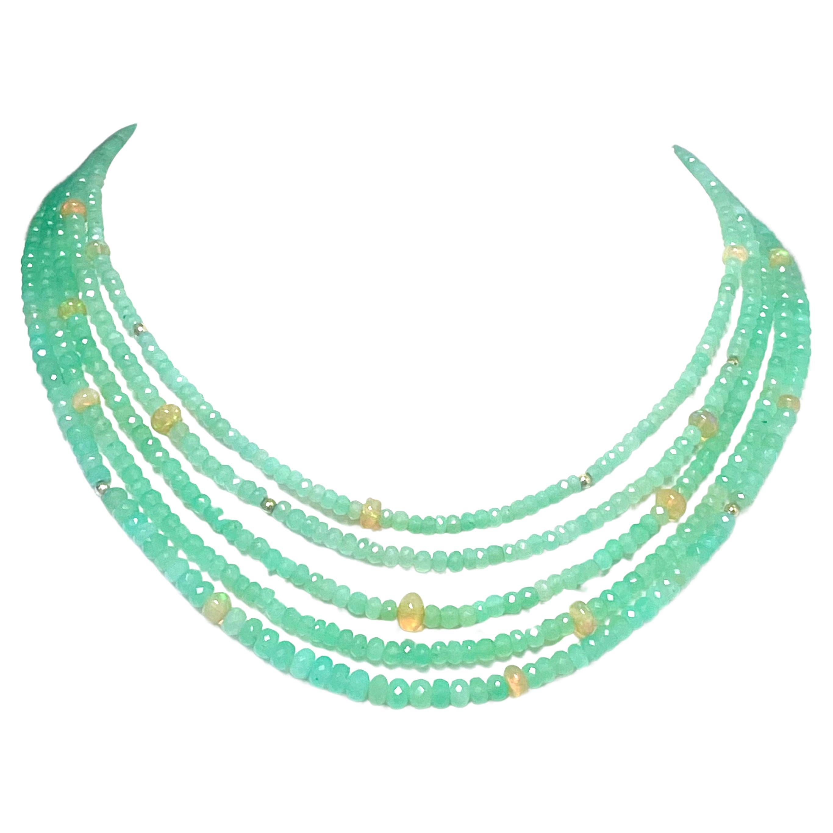 Description
Lovely soft green Chrysoprase cool as a summer breeze and delightfully compatible with fiery yellow Ethiopian Opals and twinkling faceted gold balls scattered about on five strands nested in perfect harmony… sooo subtle and feminine.