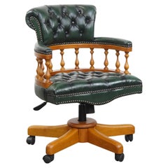 Green classic chesterfield office chair made of cowhide leather on wheels