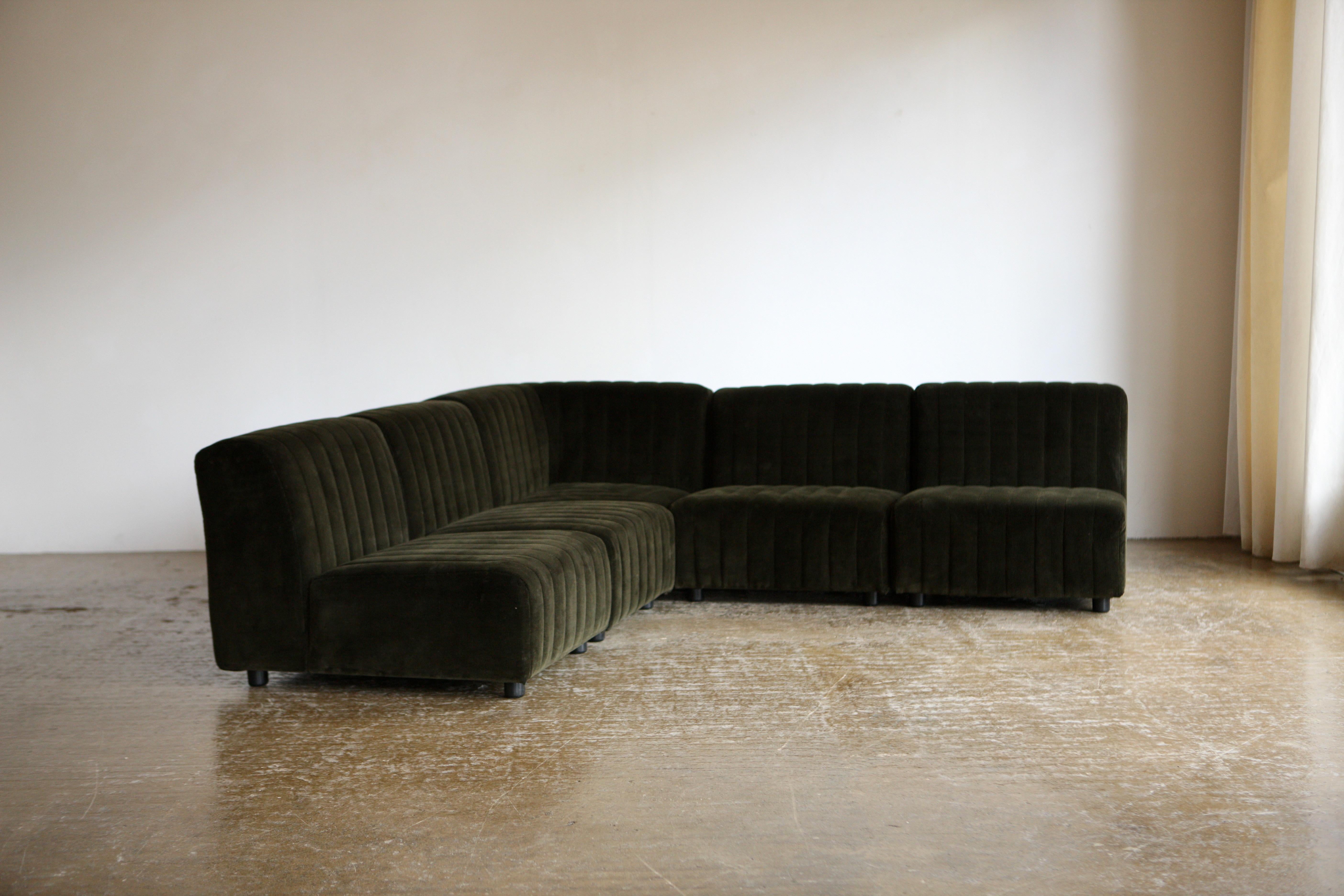 A modular 1970's Italian sofa which has been reupholstered relatively recently in Rose Uniacke bottle green cotton corduroy. The 5 piece elemental sofa has multiple configurations.

