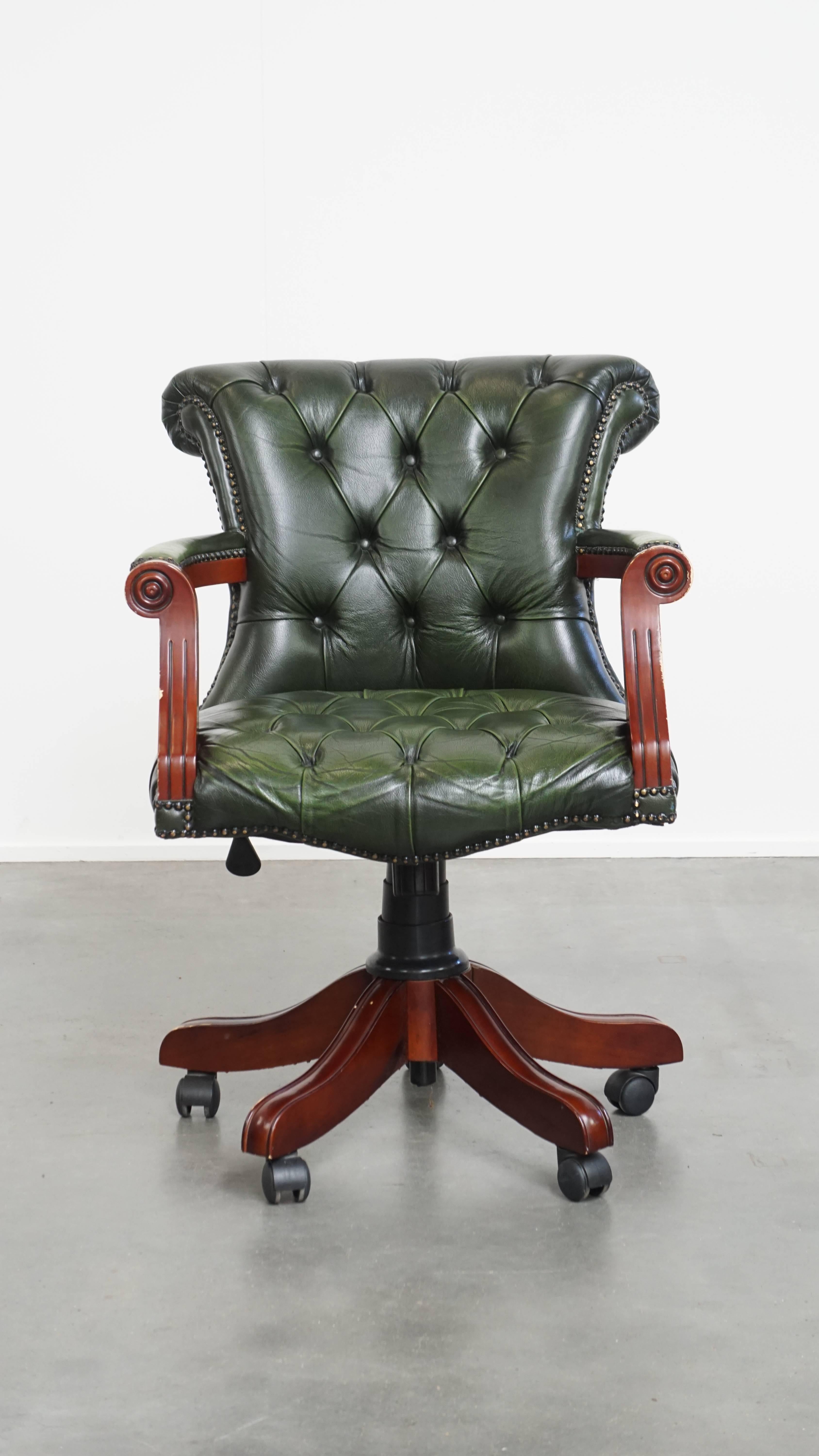 Offered here is this timeless green cowhide leather Chesterfield office chair in classic English style on wheels. 

This charming green leather and wood office chair is a timeless addition to any workspace. It swivels, tilts, and is height