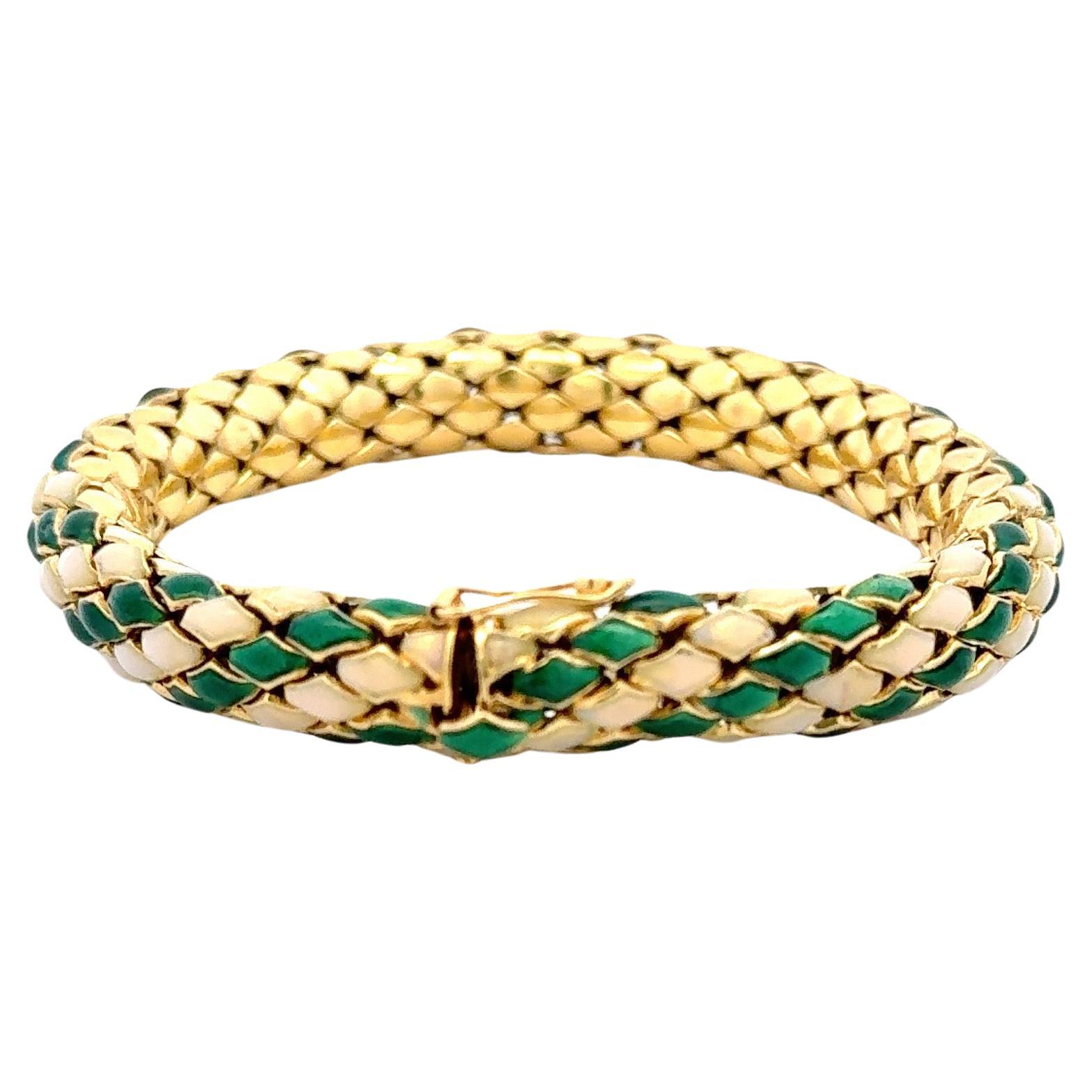 Vintage 18 karat yellow gold snake motif bracelet featuring green and cream enamel weighing 55.9 grams. 
