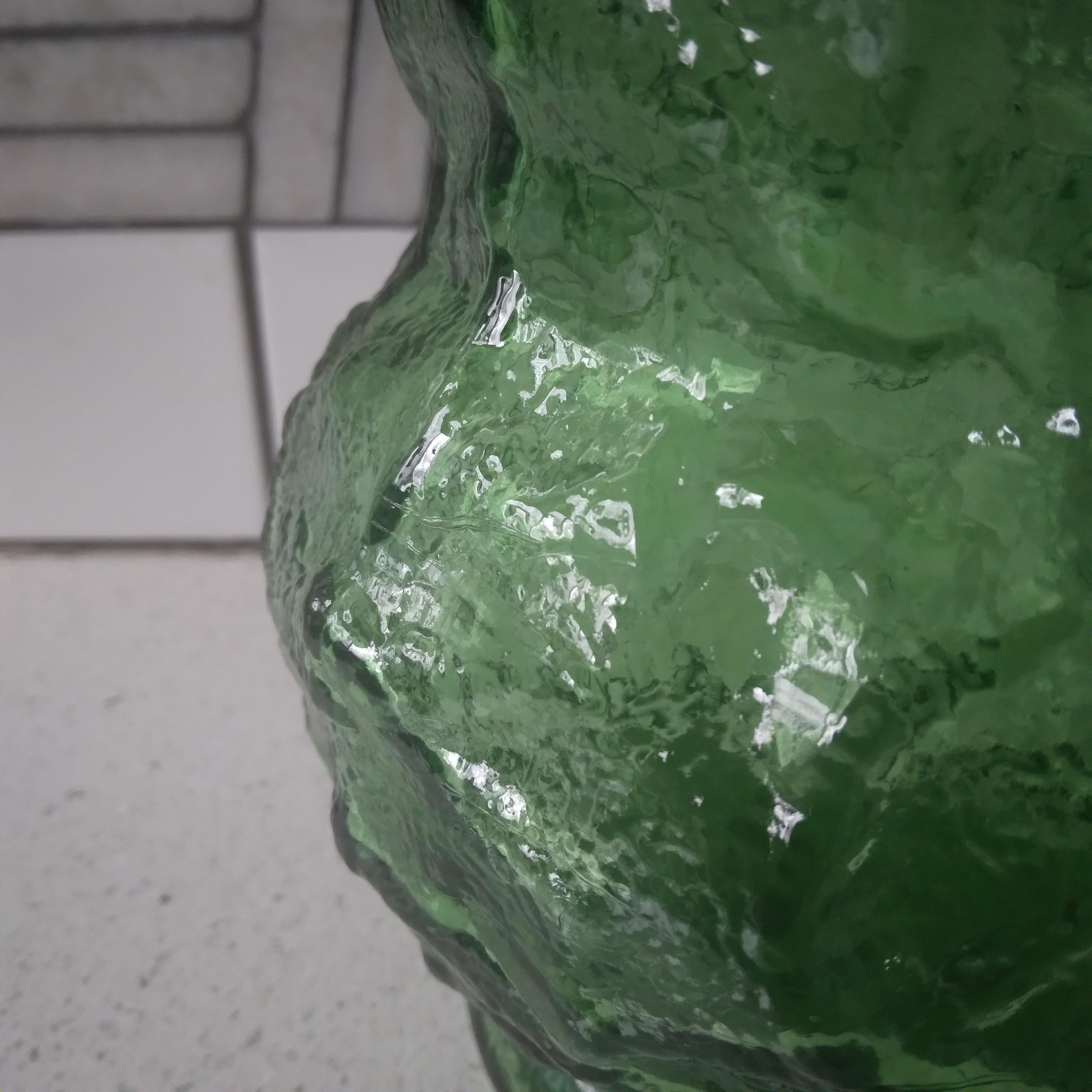 Bottle green glass in a retro crinkle design, this vintage vase is ready to display the beauty of nature. We love her vibrant color and generous curves!   She is large enough to fit a full bouquet and the translucent green with go wonderfully with a