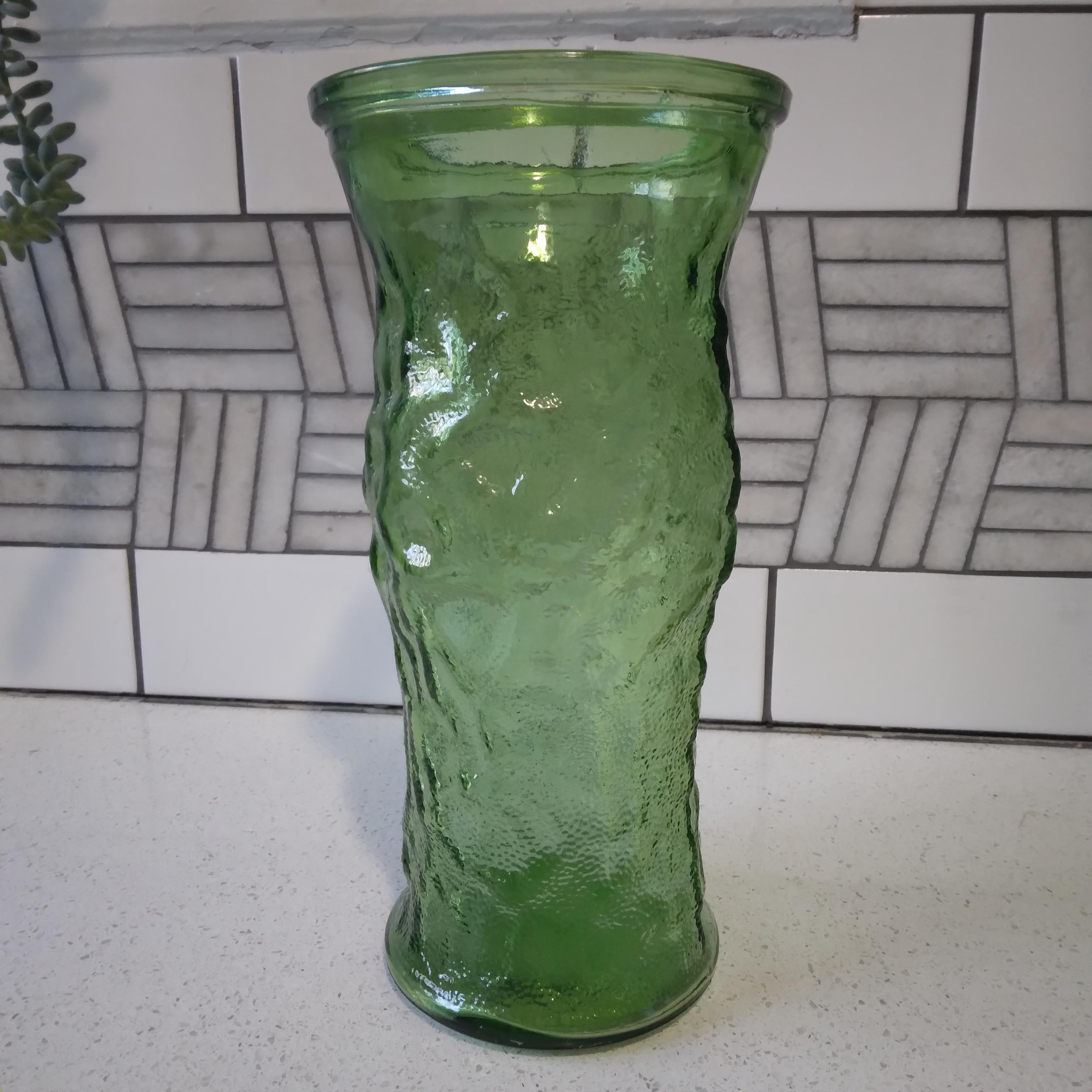 Bottle green glass in a retro crinkle design, this vintage vase is ready to display the beauty of nature. We love her vibrant color and generous curves!   She is large enough to fit a full bouquet and the translucent green with go wonderfully with a