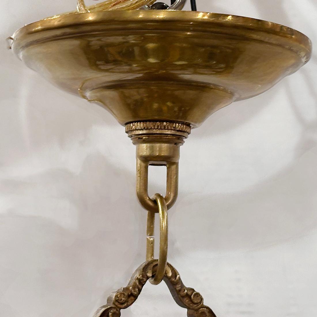 A circa 1920's French 1920's light fixture with crystals and 4 candelabra lights.

Measurements:
Drop: 17
