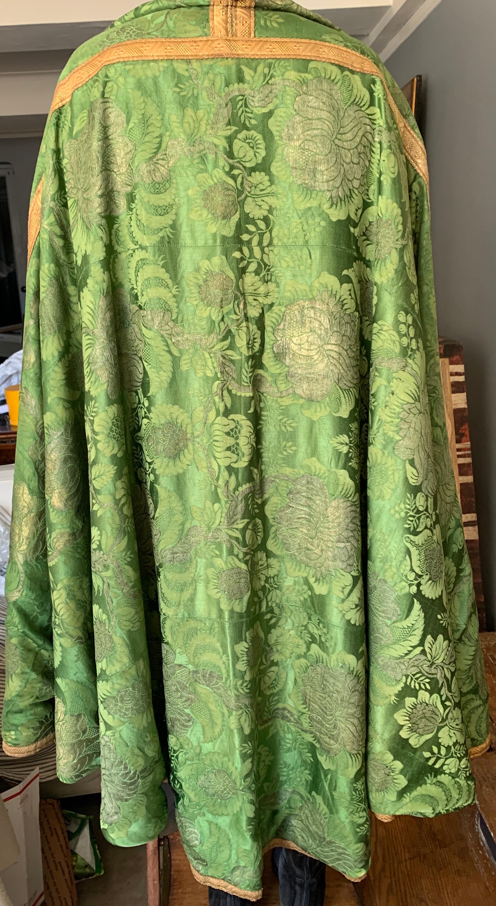 Green damask and gilt thread chasuble cape. Large floral damask in gold thread on green silk ground textile. Italy, circa 1800
Dimensions: 96