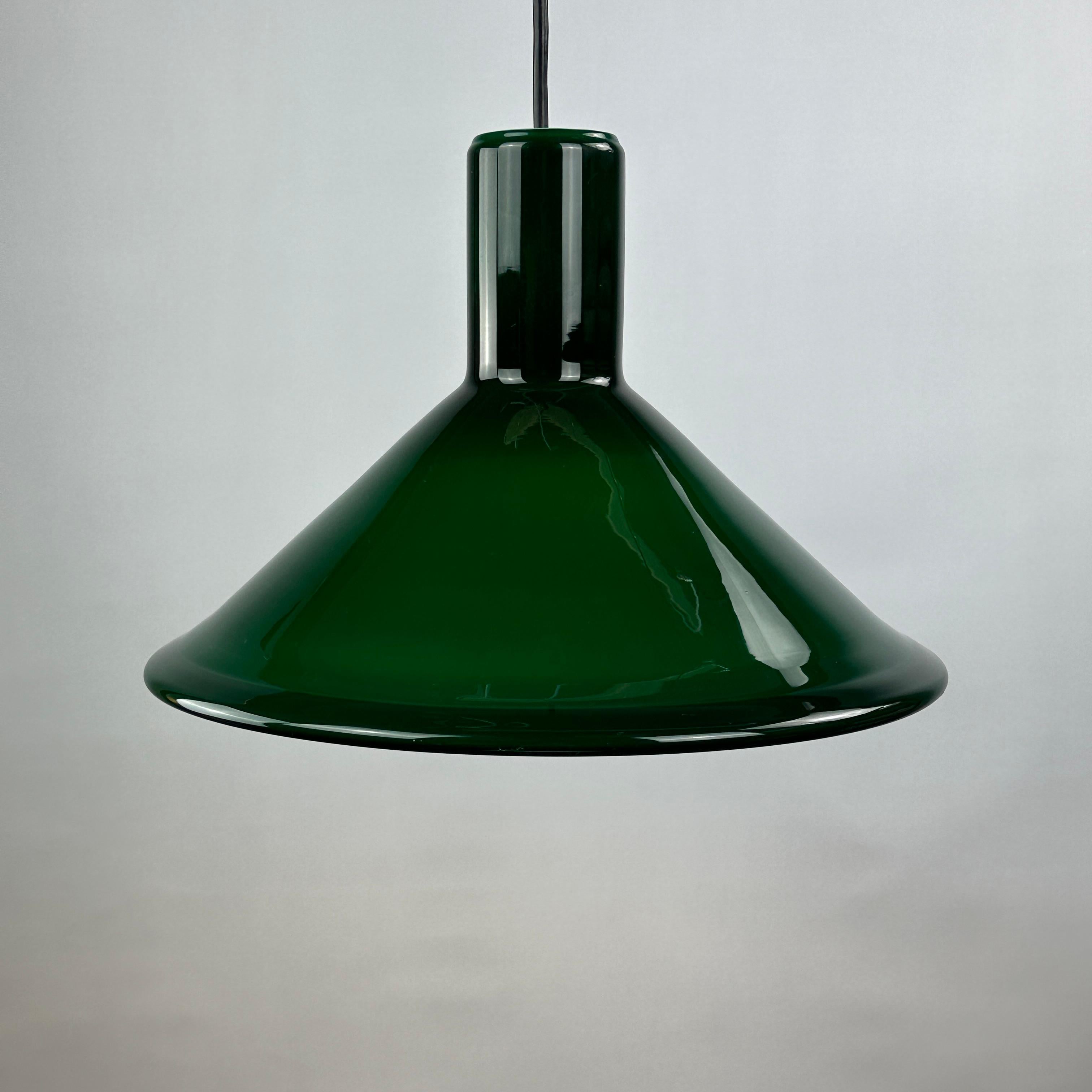 Cool and stylish green thick glass pendant light by the Danish Michael Bang for Holmegaard. This model is called P & T PENDEL and was designed in 1972.

High quality thick opaline glas, gives a very pleasant light. Holmegaard specialized in mouth