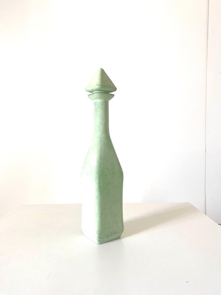 A vintage green decorative bottle. Manufactured in Italy in the 1960s. Green painted glass.