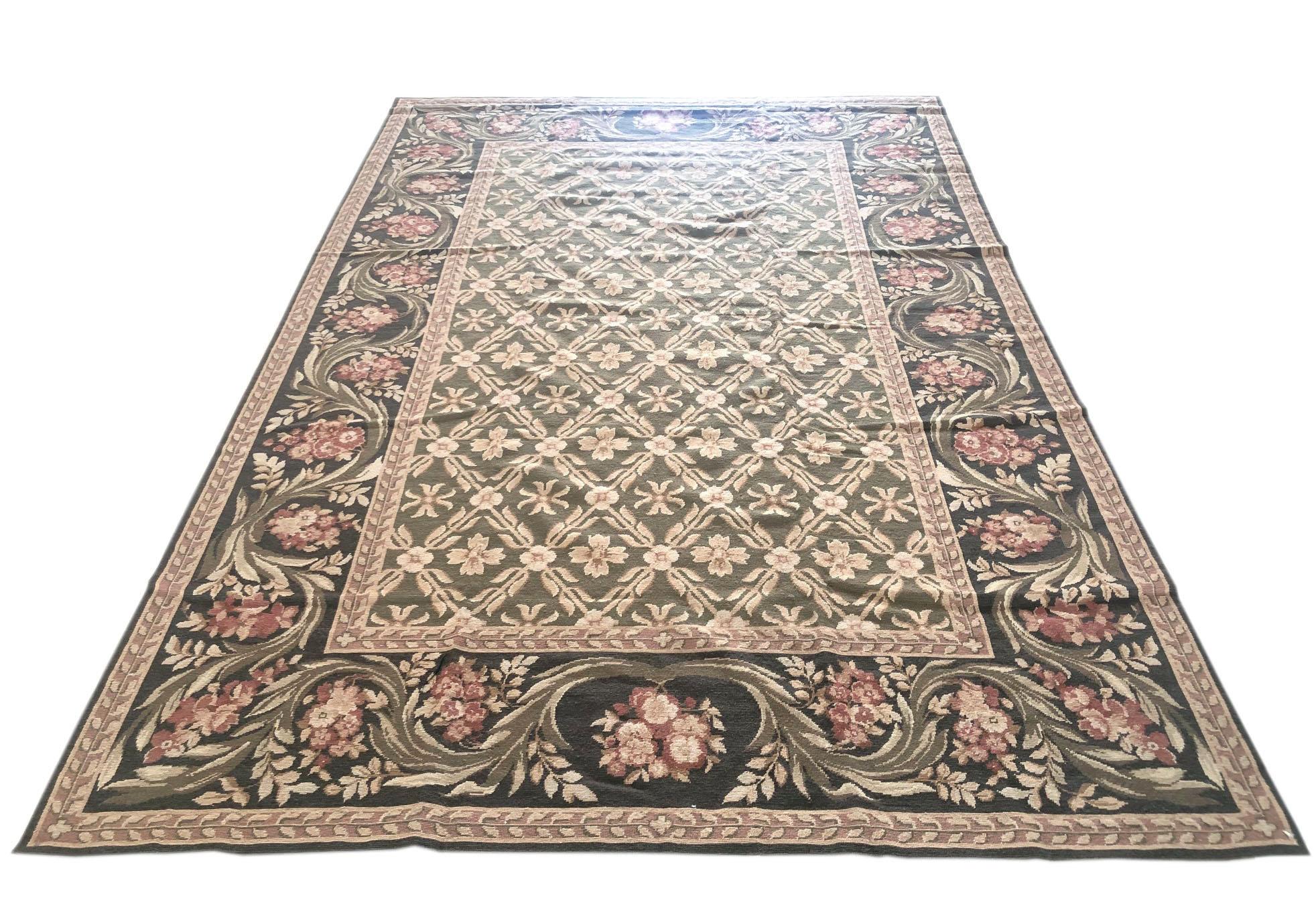 This piece is a floral diamond design needle point Chinese rug. The base color and border colors are both green in different tones. The size is 5 feet wide by 9 feet tall. This is a brand new rug.