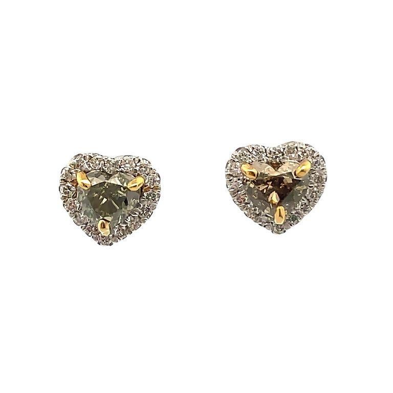 We are pleased to present our exquisite green heart shape diamonds with a total of two-carat weight, selected for their color and brilliance. The diamonds are set in a white halo design made in eighteen-carat gold in two-tone, the prongs for the