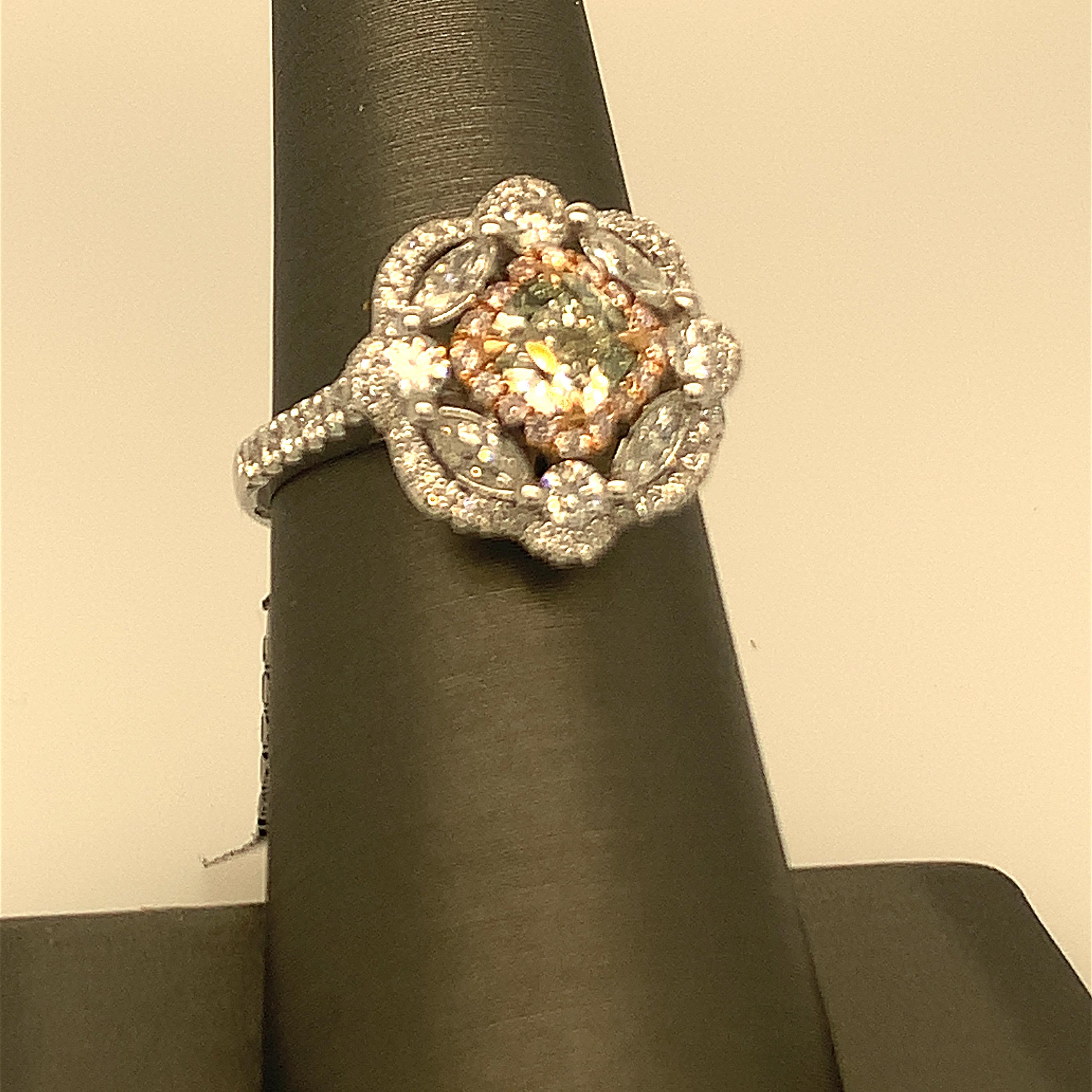 Natural green diamonds solitaire cushion 0.85, additional white marquises and round plus Halo of pink diamonds is one of a kind handcrafted Ring. The size of the Ring is 7 but can be resized two size up or two size down easily.